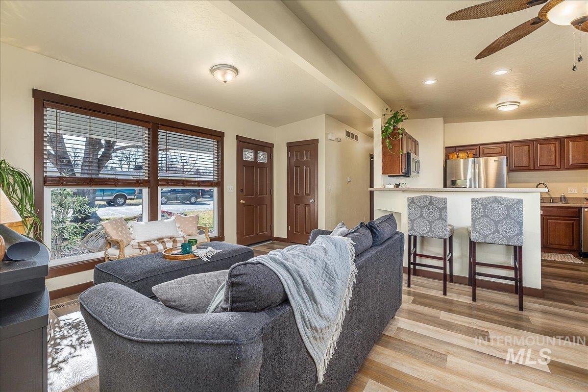 Living room featuring ceiling fan, light wood-style flooring, and recessed lighting