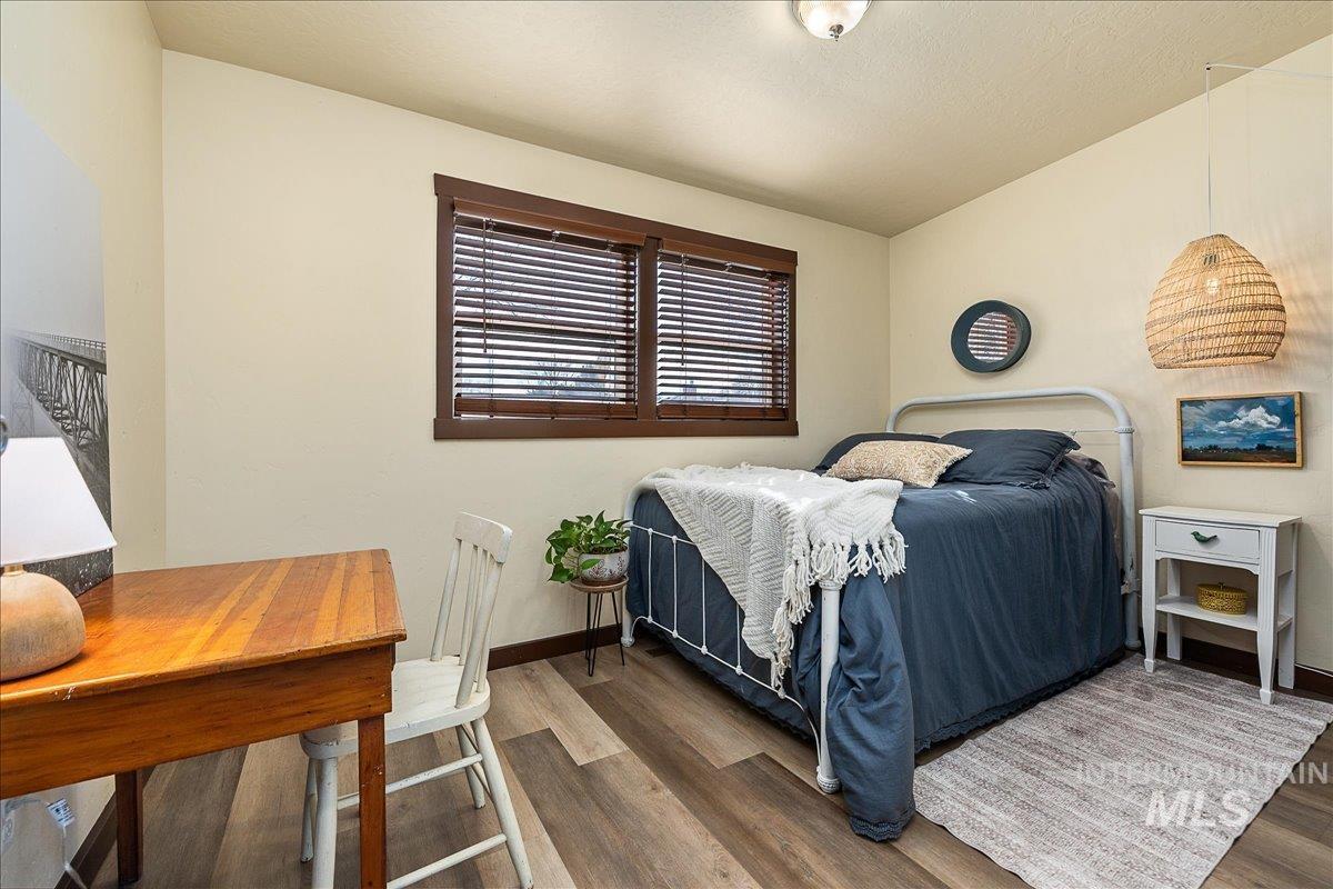Bedroom featuring wood finished floors and vaulted ceiling