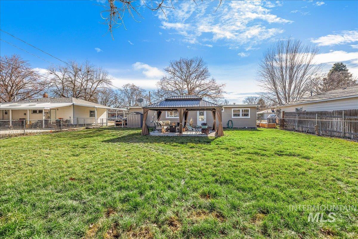 Back of house featuring a gazebo, a fenced backyard, and a patio area