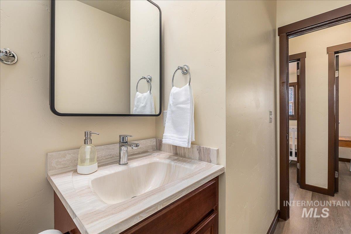 Half bathroom with vanity and a textured wall