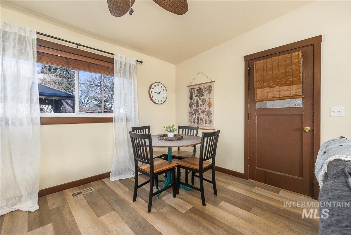 Dining space featuring light wood finished floors, a ceiling fan, and lofted ceiling
