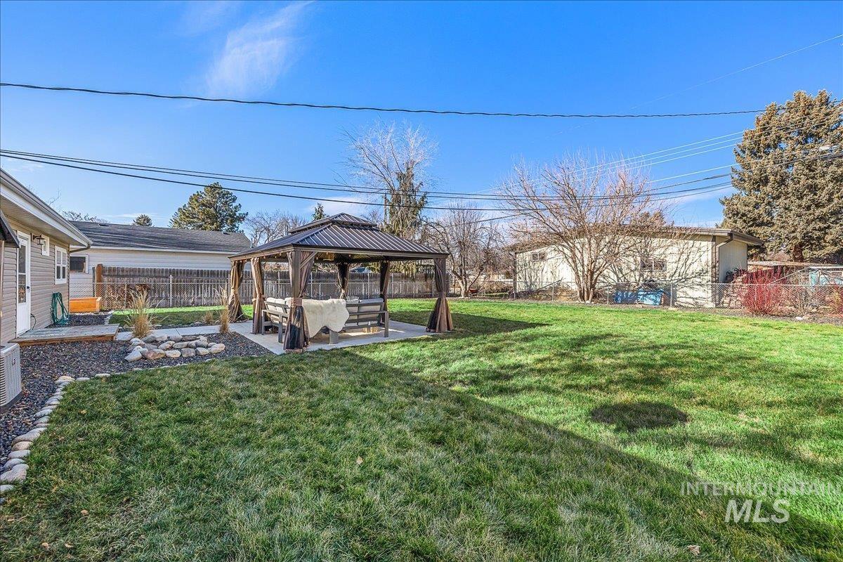 Fenced backyard with a gazebo and a patio area