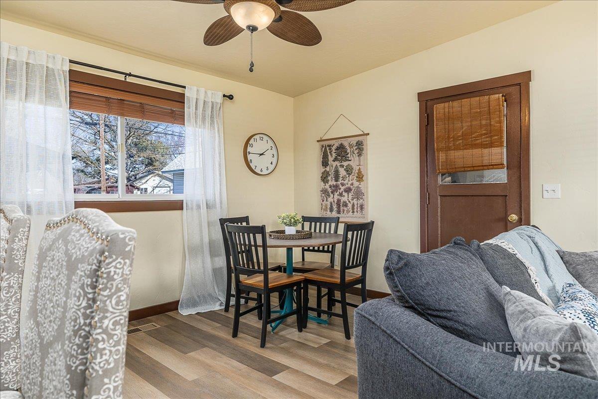 Dining room with light wood-style flooring and a ceiling fan