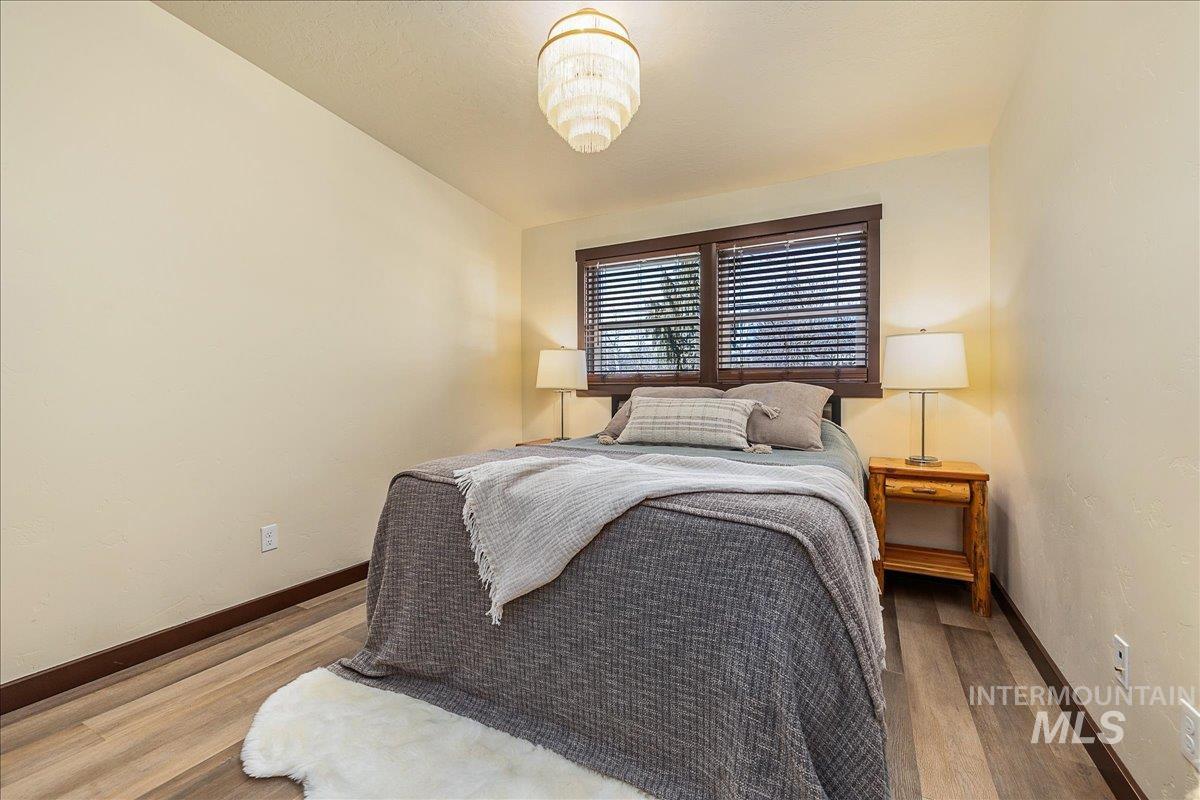 Bedroom with baseboards and wood finished floors