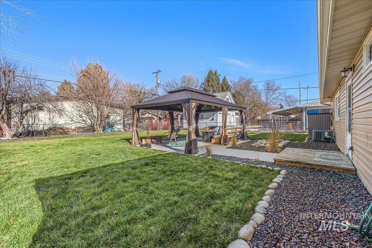 Fenced backyard with a gazebo and a patio area