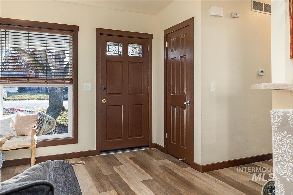 Foyer entrance with wood finished floors