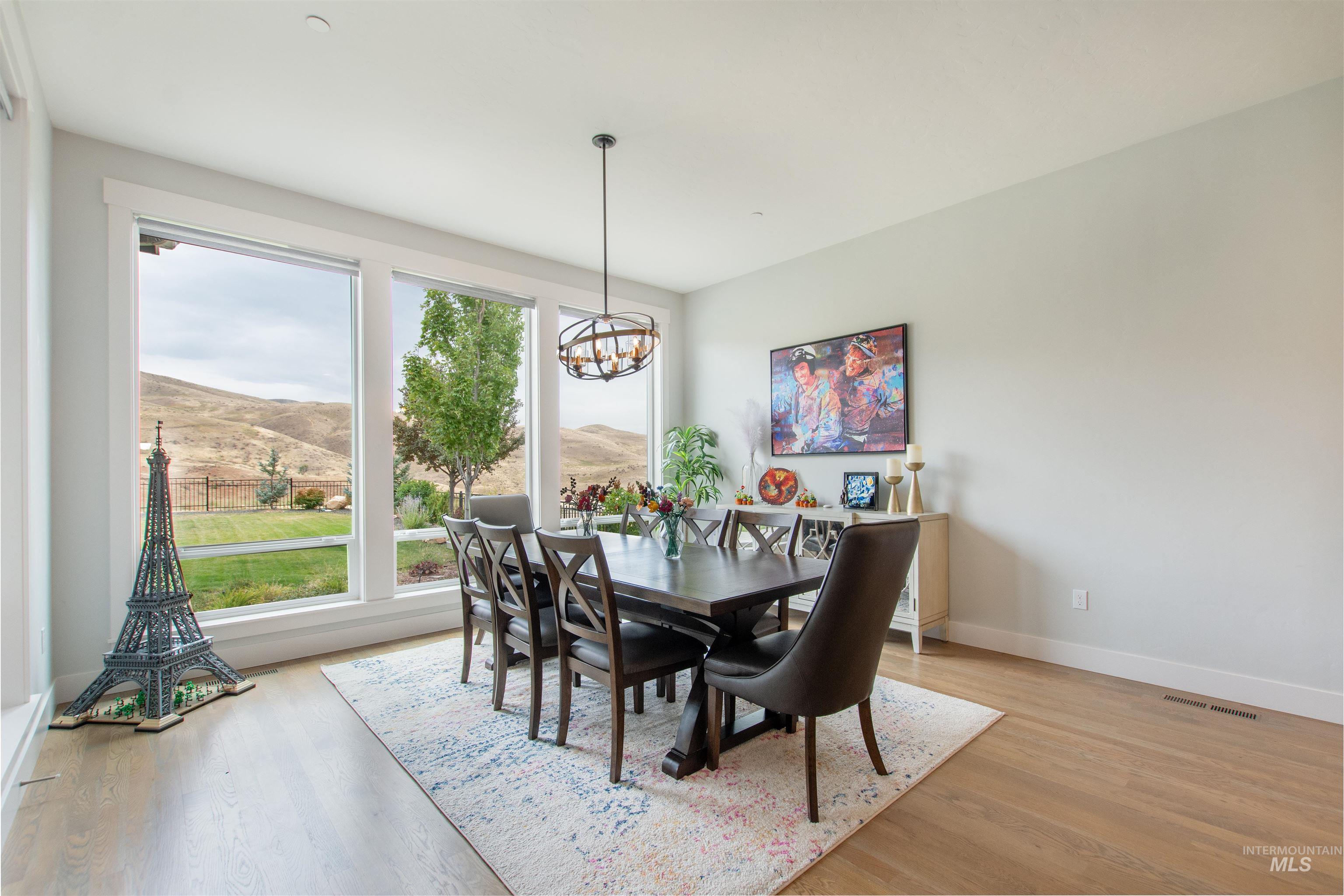Dining room featuring a mountain view, light wood-type flooring, and a chandelier