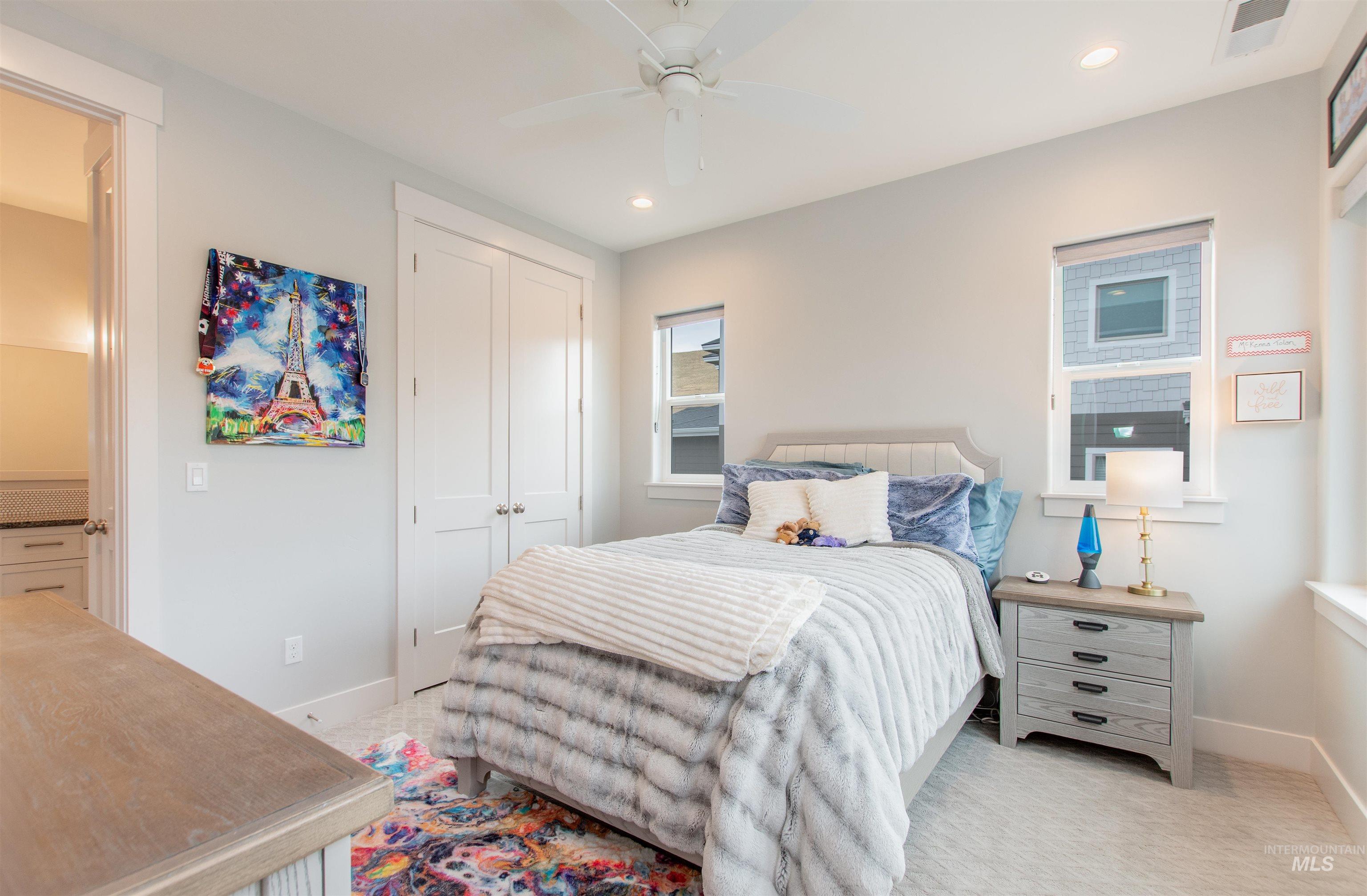 Bedroom with a closet, a ceiling fan, light carpet, and recessed lighting