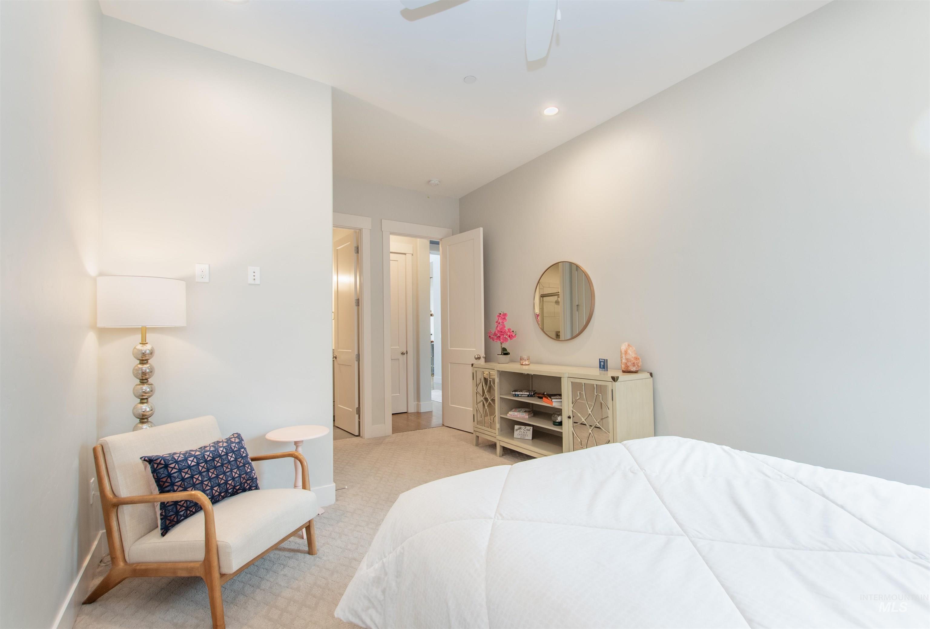 Bedroom featuring light colored carpet, ceiling fan, and recessed lighting