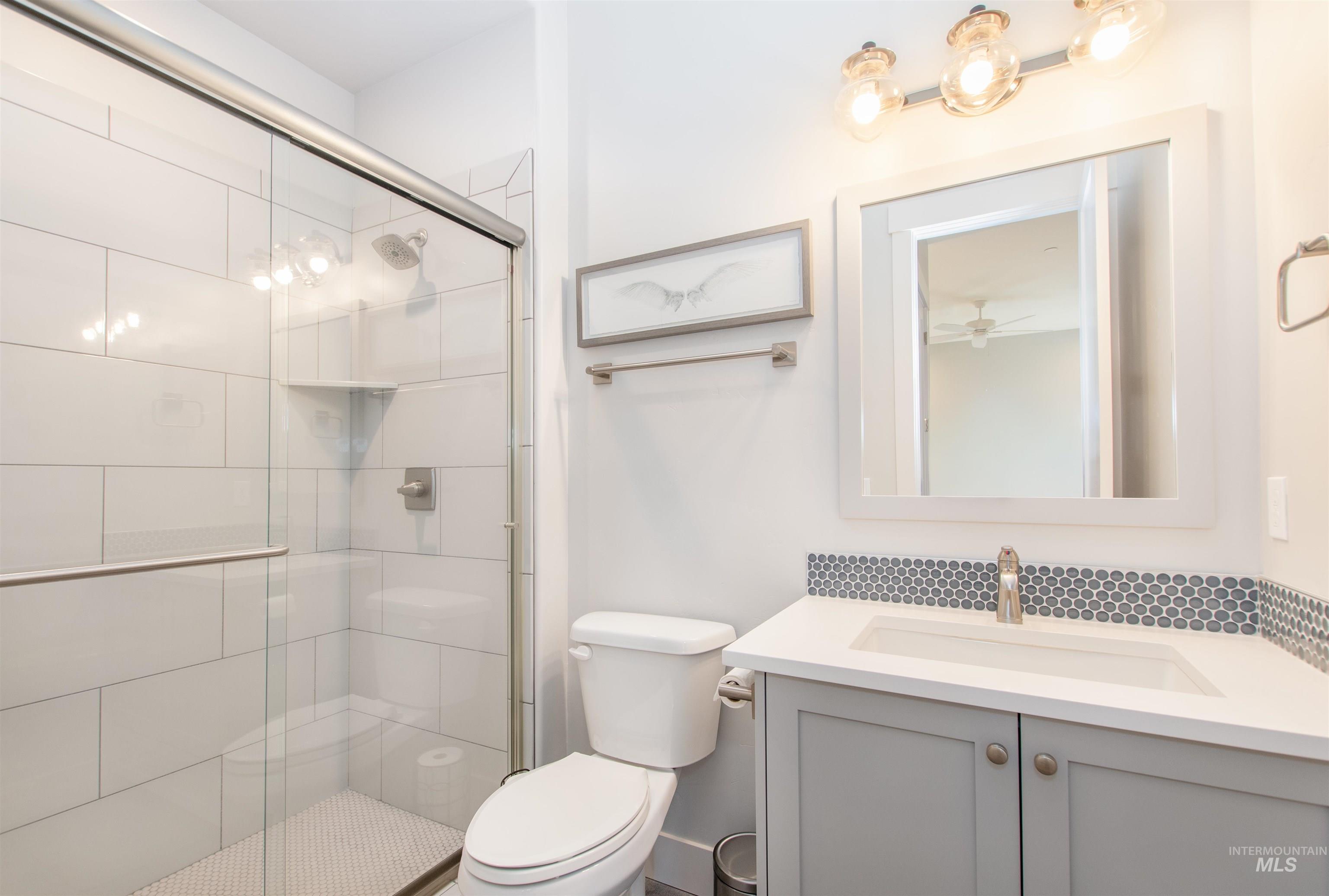 Full bath featuring vanity and a stall shower