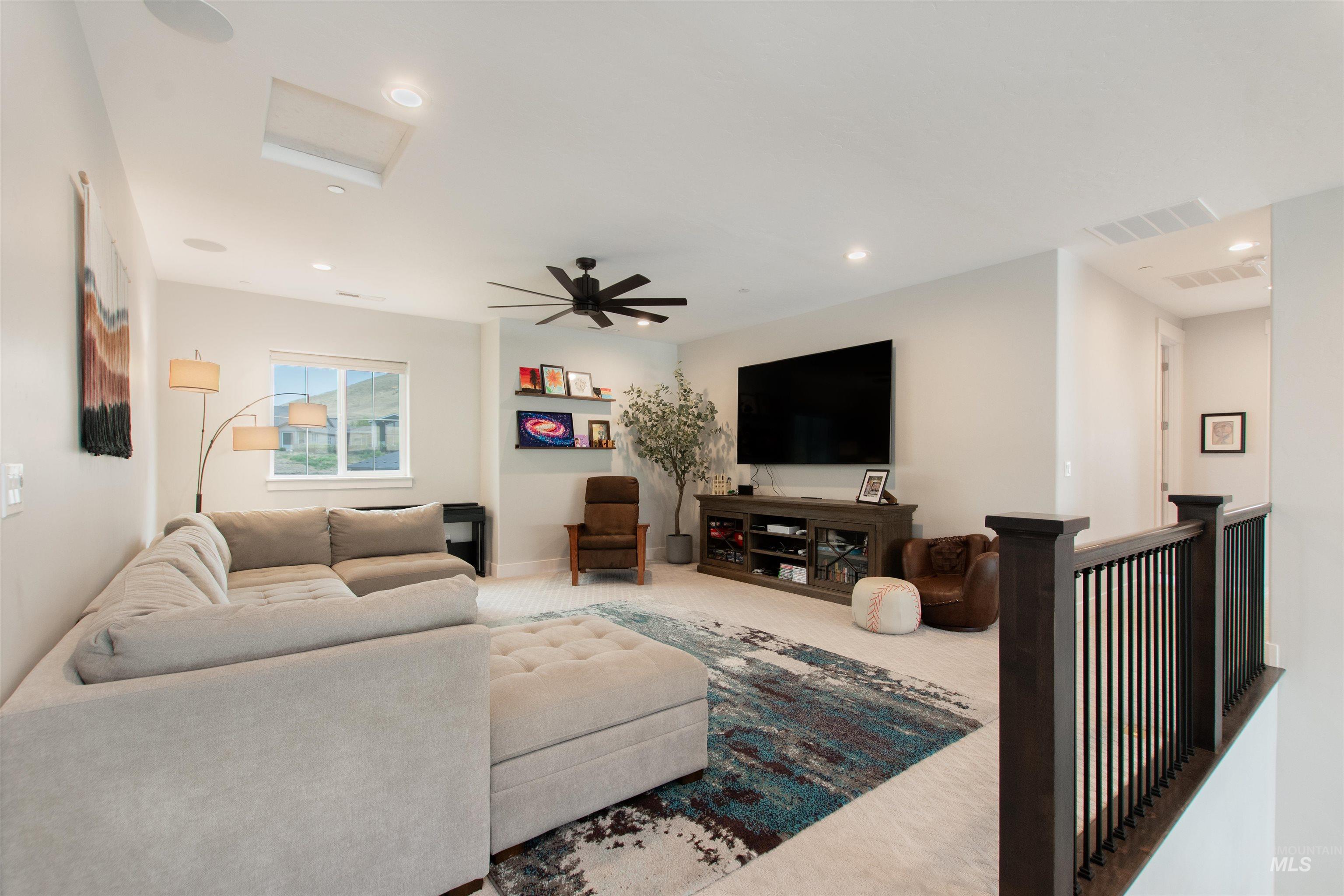 Living room featuring carpet, attic access, recessed lighting, and a ceiling fan