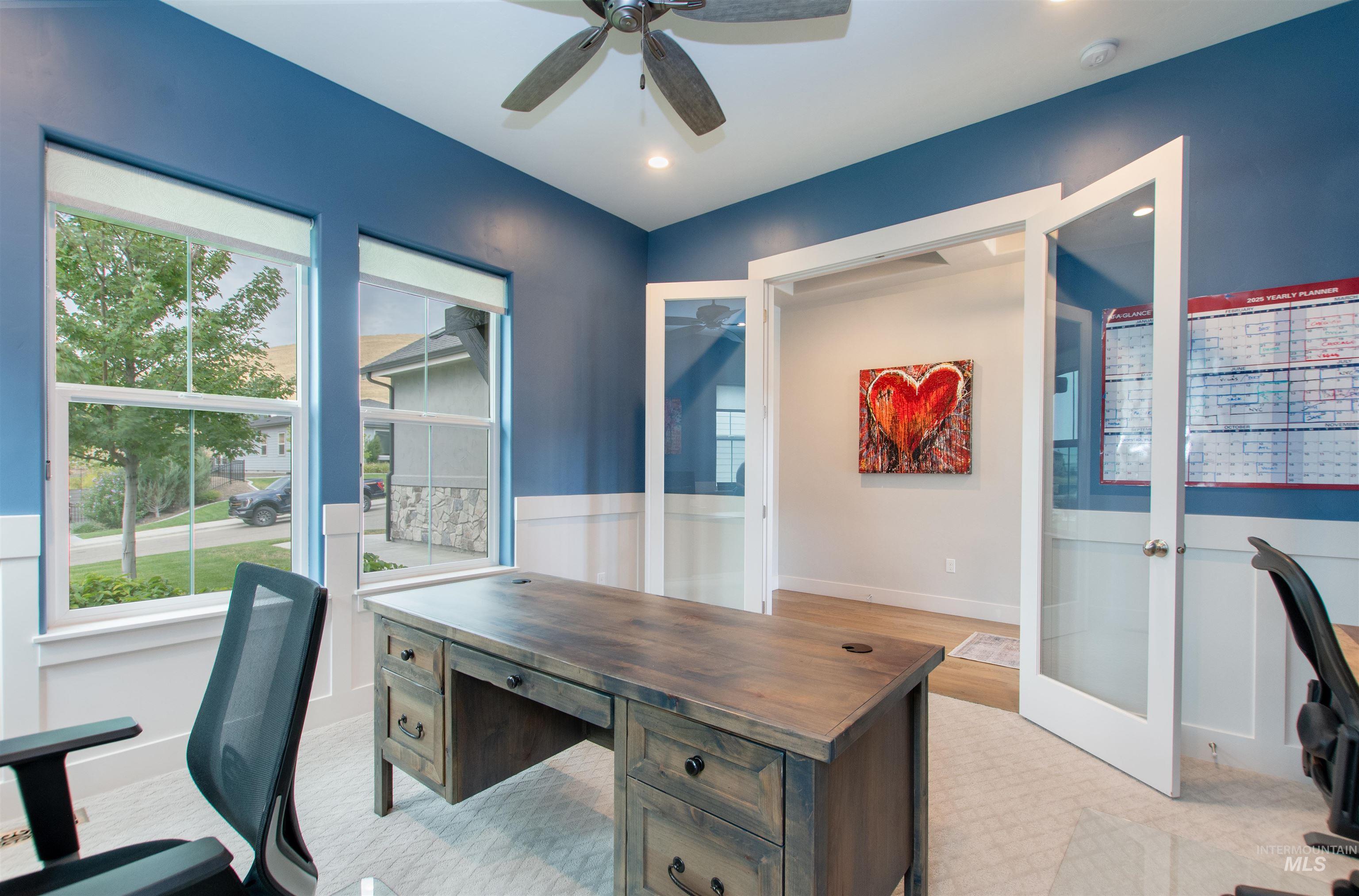 Office space with french doors, healthy amount of natural light, light colored carpet, and recessed lighting
