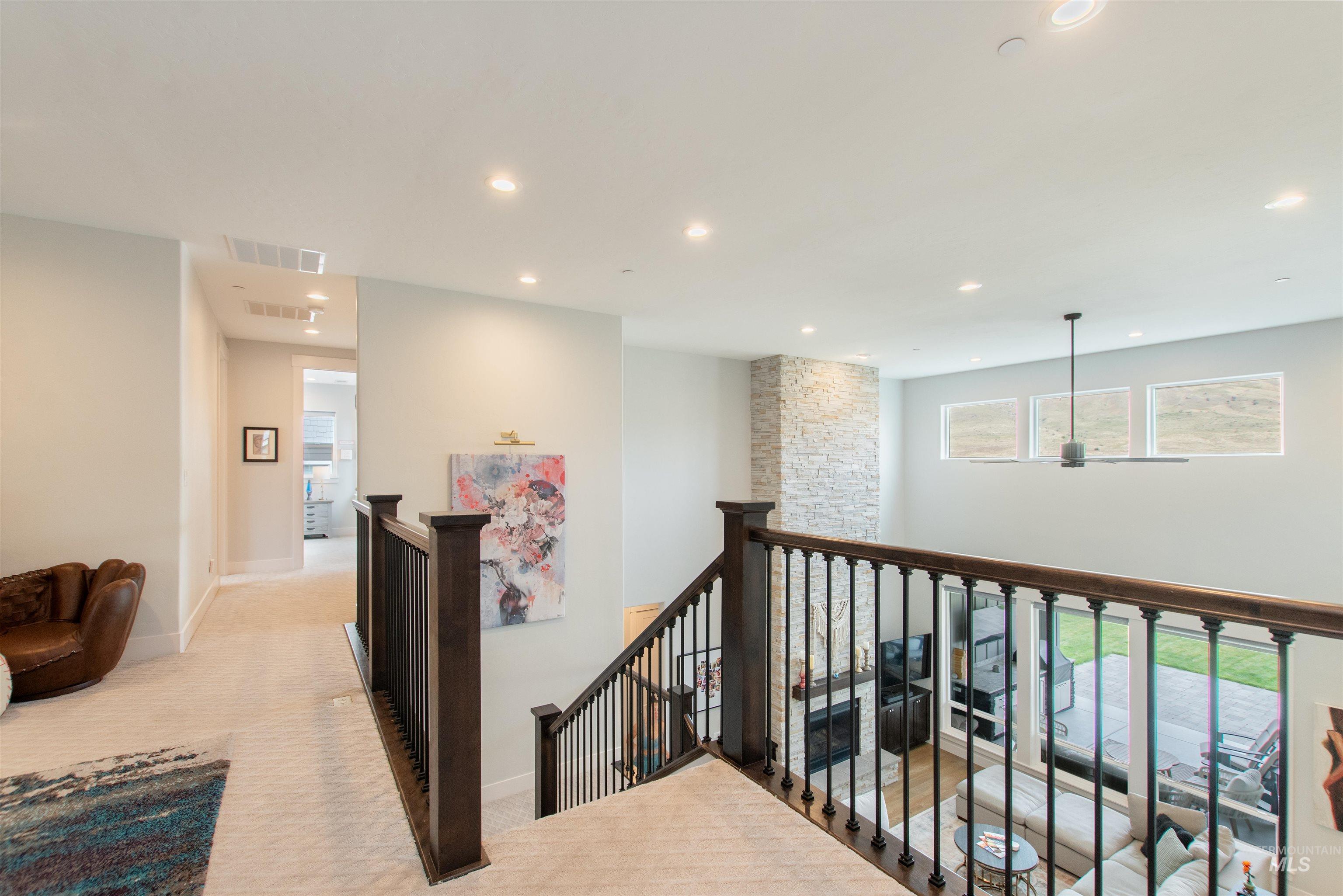 Corridor featuring an upstairs landing, recessed lighting, and light carpet