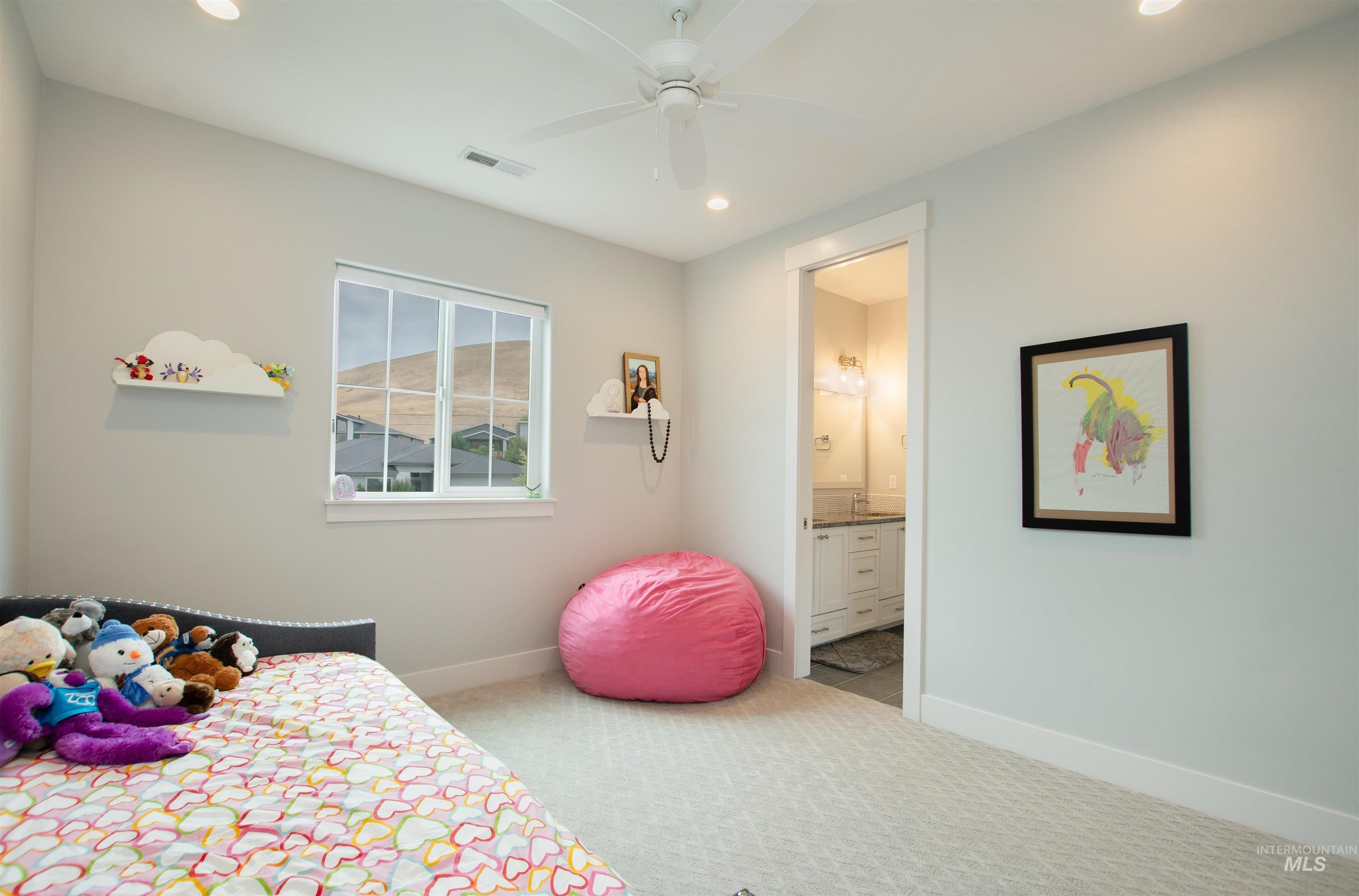 Bedroom with light carpet, recessed lighting, a ceiling fan, and connected bathroom