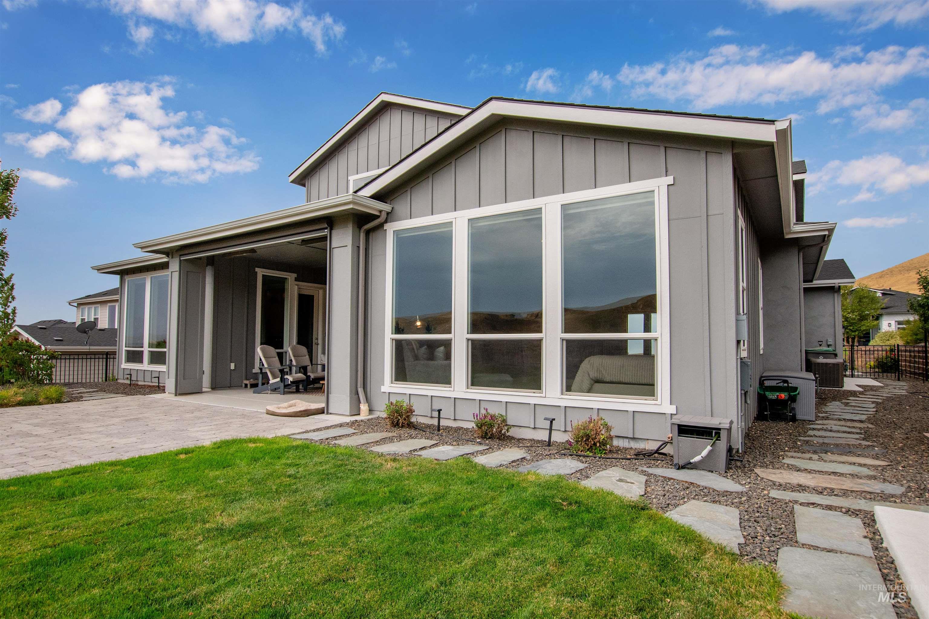 Rear view of property with board and batten siding and a patio