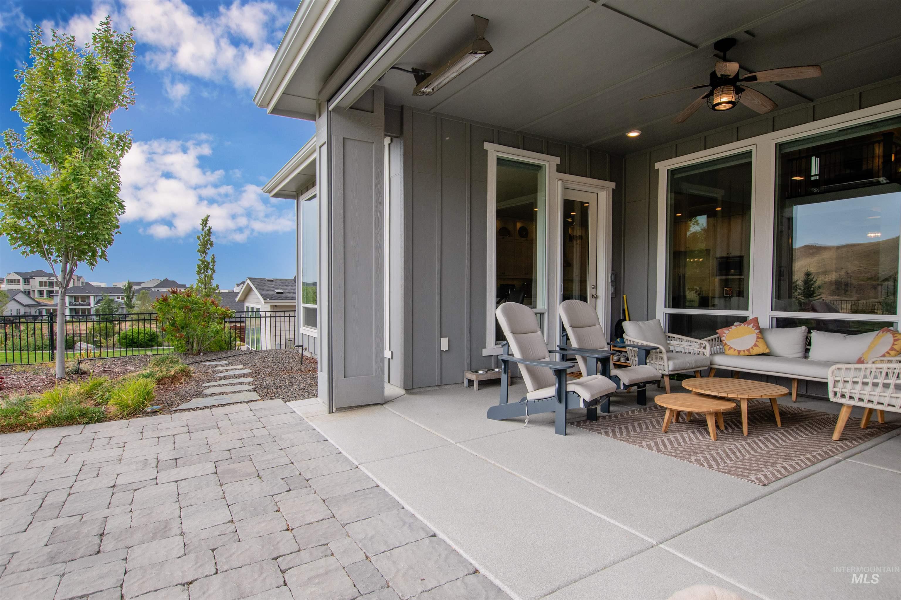 View of patio / terrace featuring a ceiling fan and a residential view