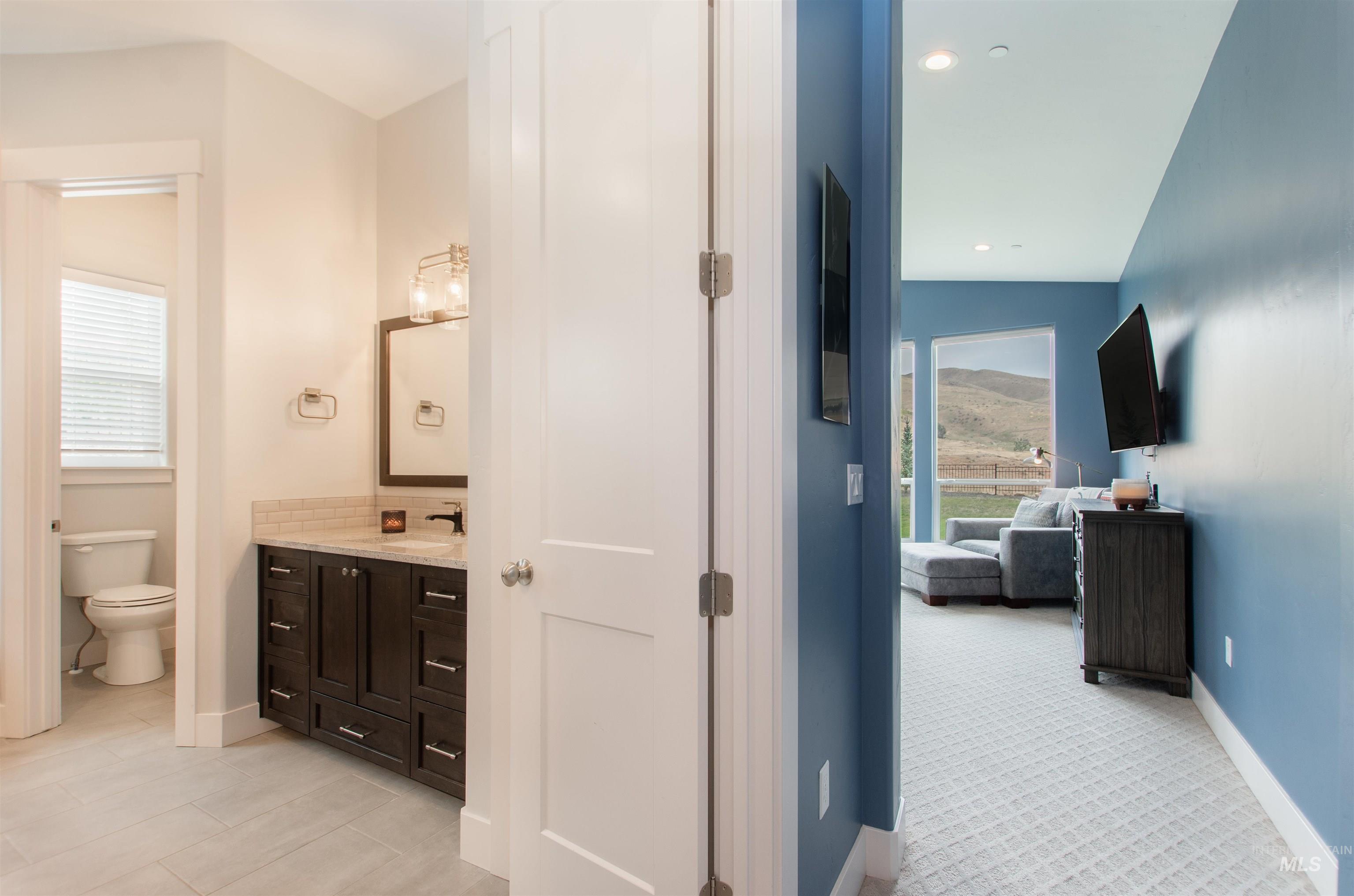 Bathroom with vanity, ensuite bath, and recessed lighting