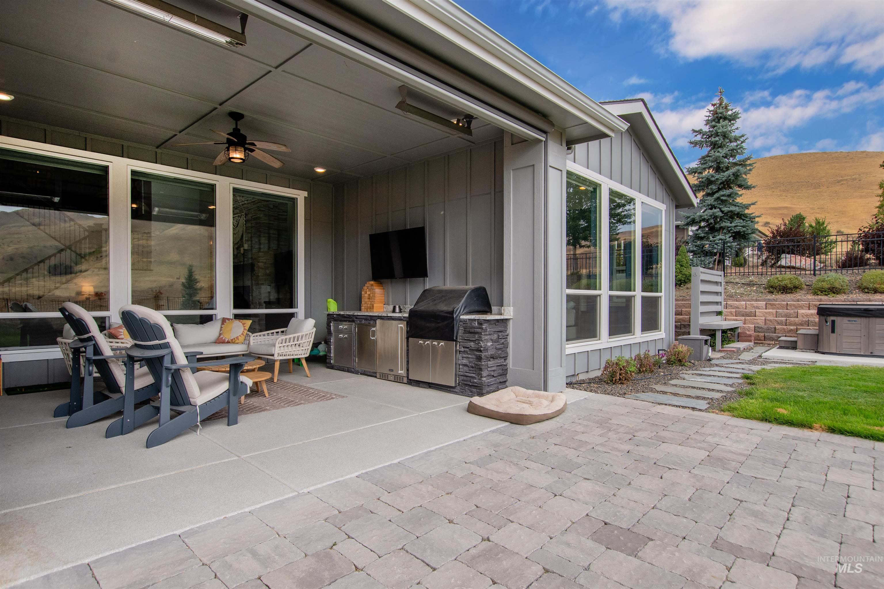 View of patio featuring an outdoor kitchen and ceiling fan