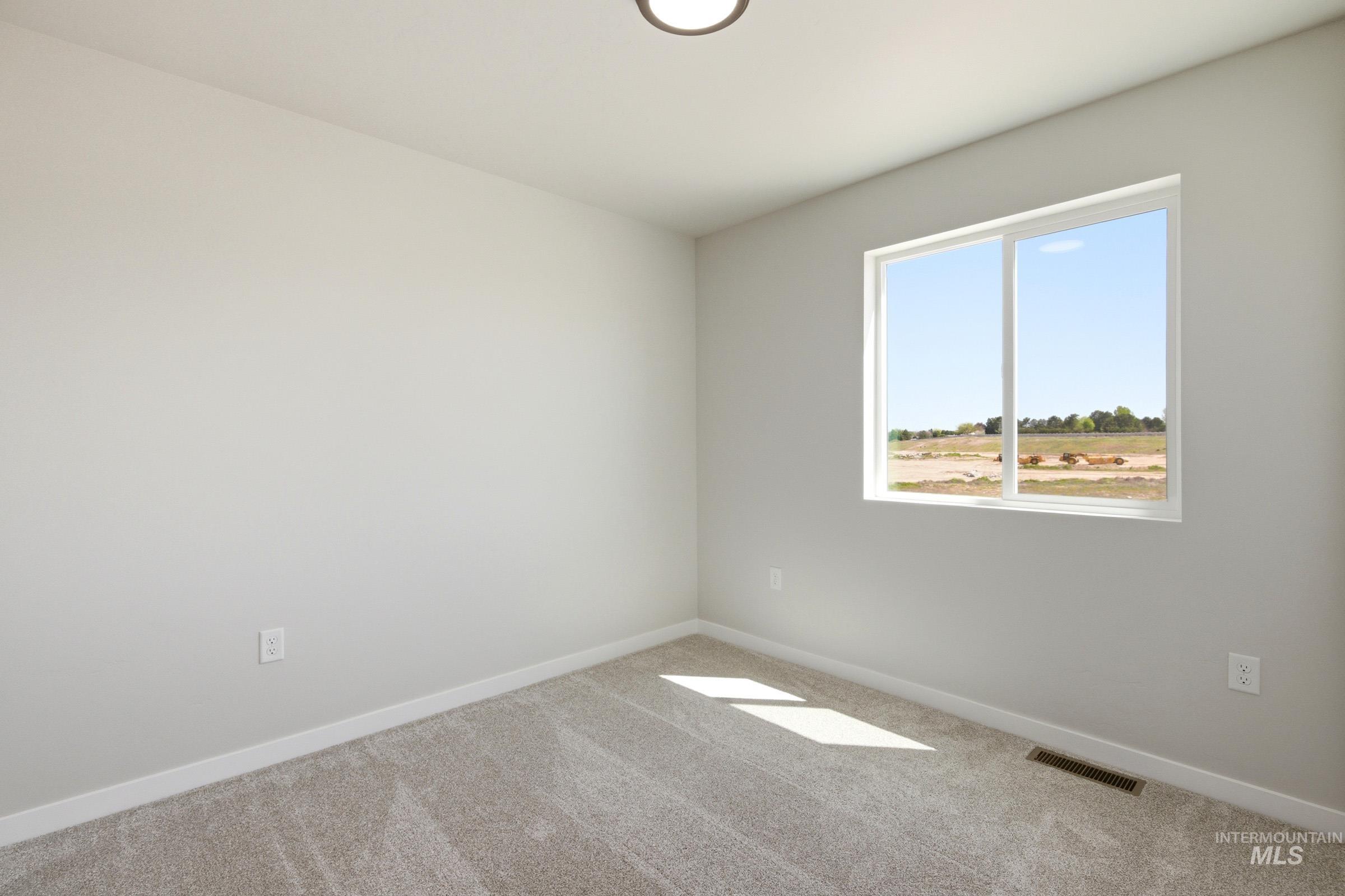 Room featuring light gray carpet, white baseboards, and neutral wall paint
