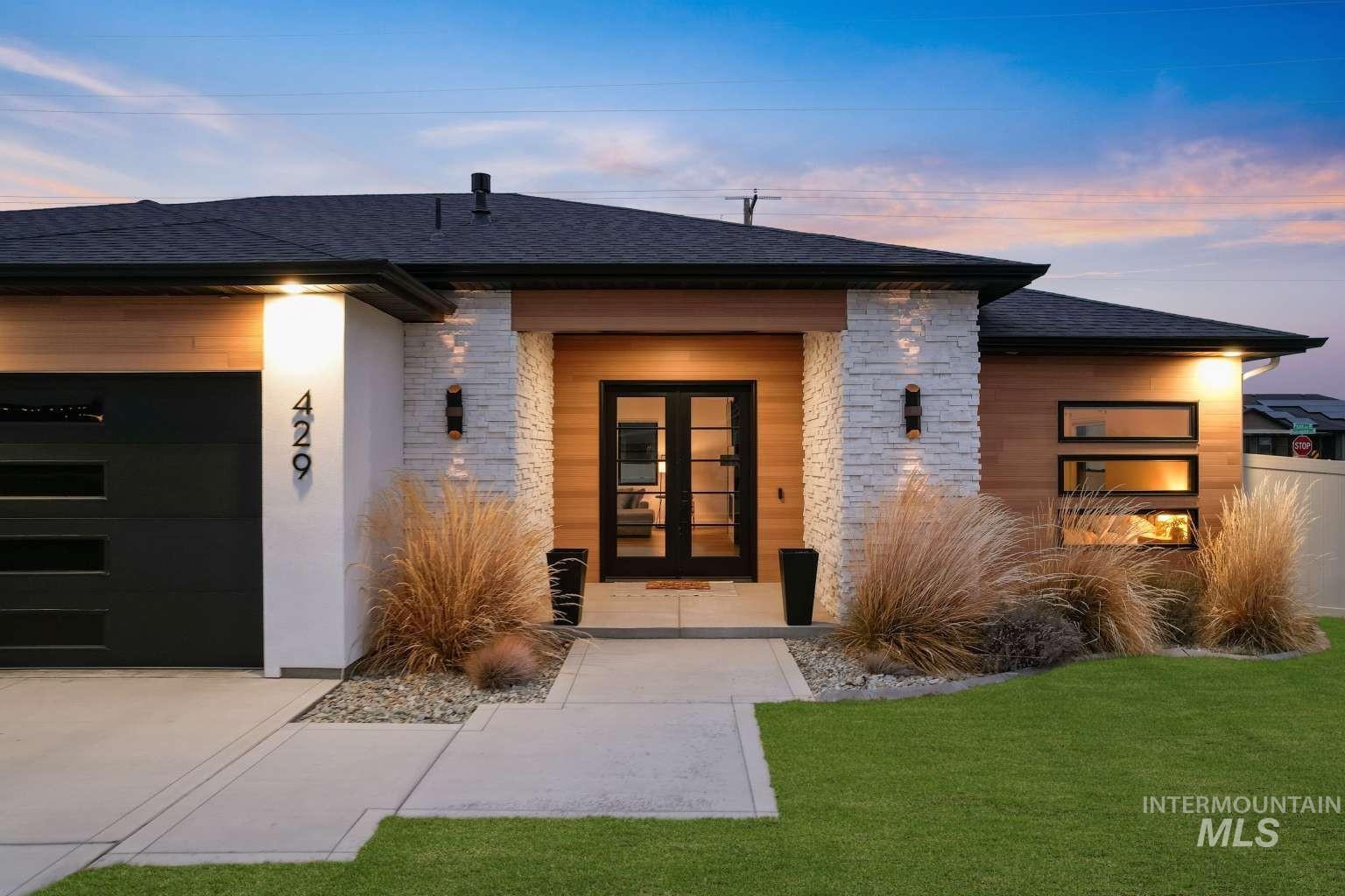 Property entrance featuring stone siding, french doors, and a shingled roof