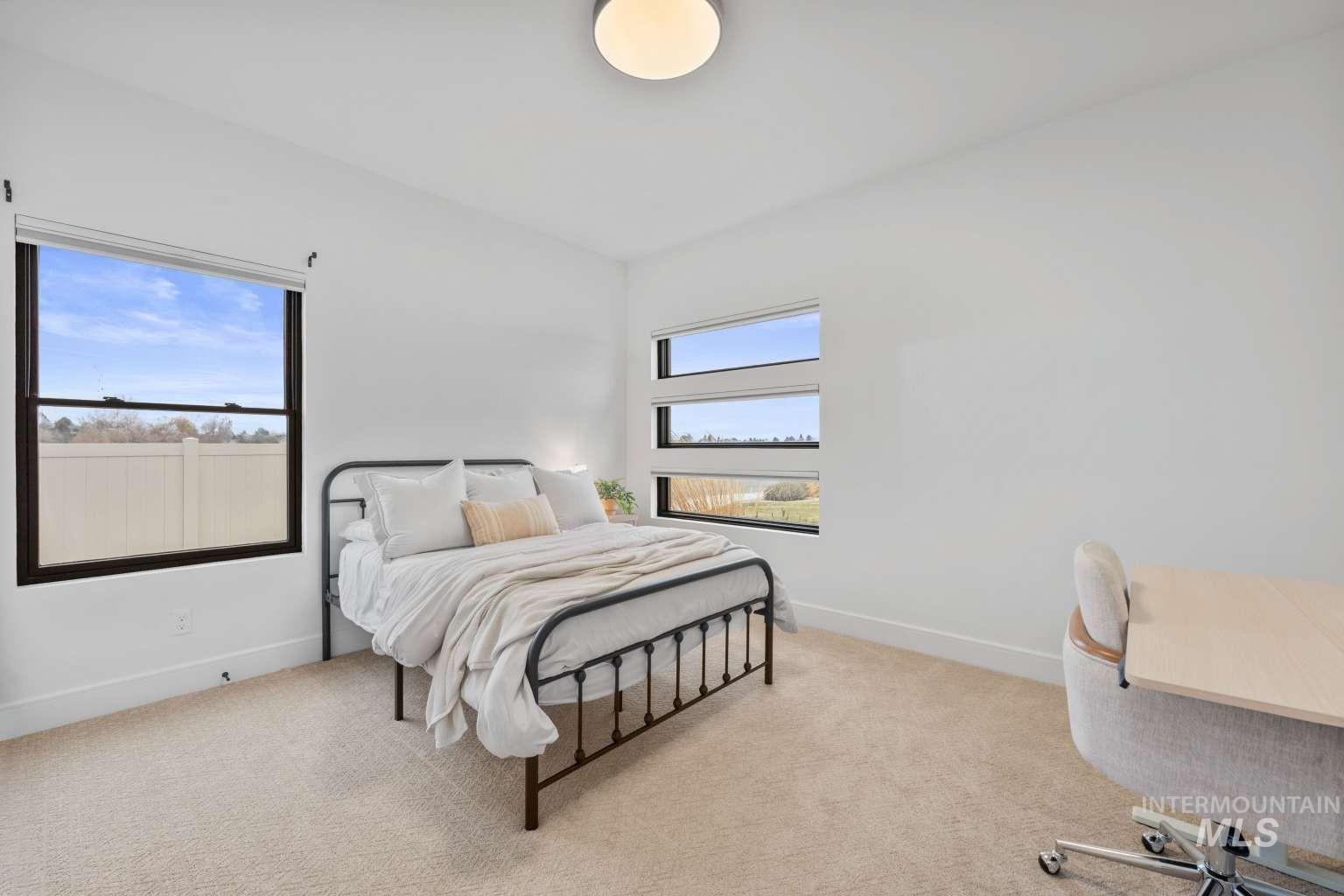 Bedroom featuring light carpet