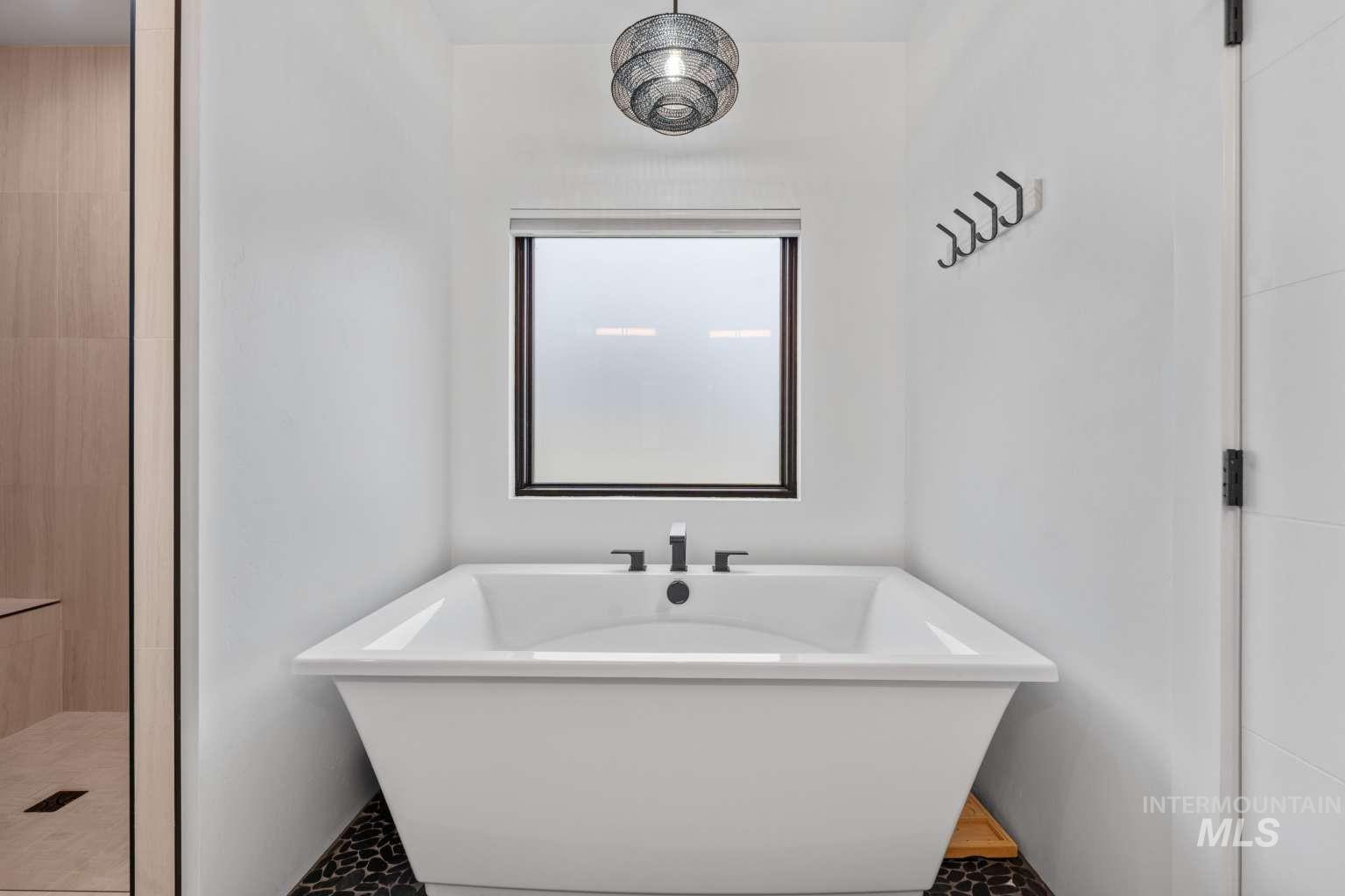 Full bath featuring a freestanding bath and tiled shower