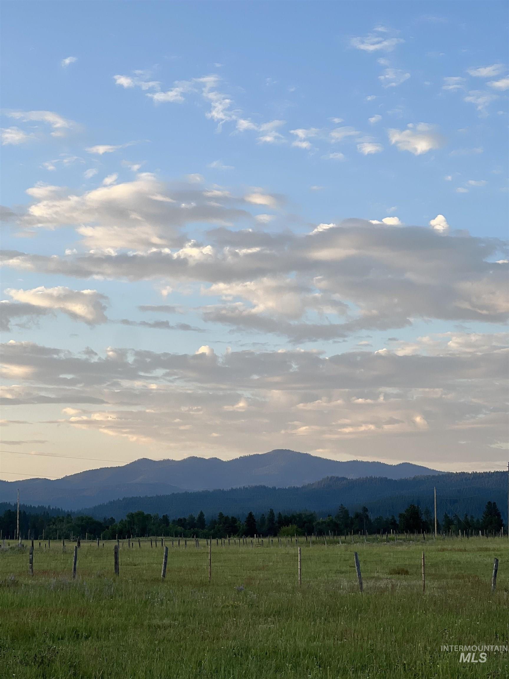 View of mountain backdrop with rural landscape