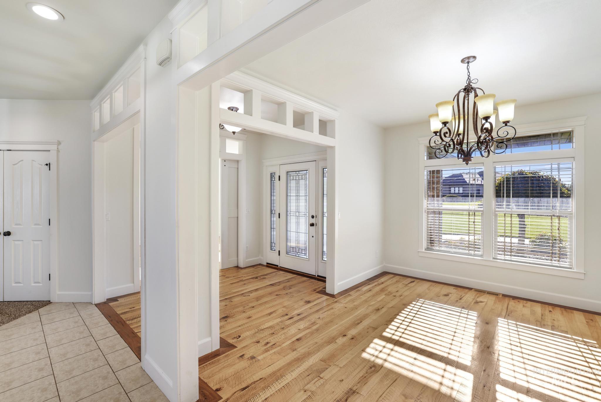 Entryway with a chandelier and light wood finished floors