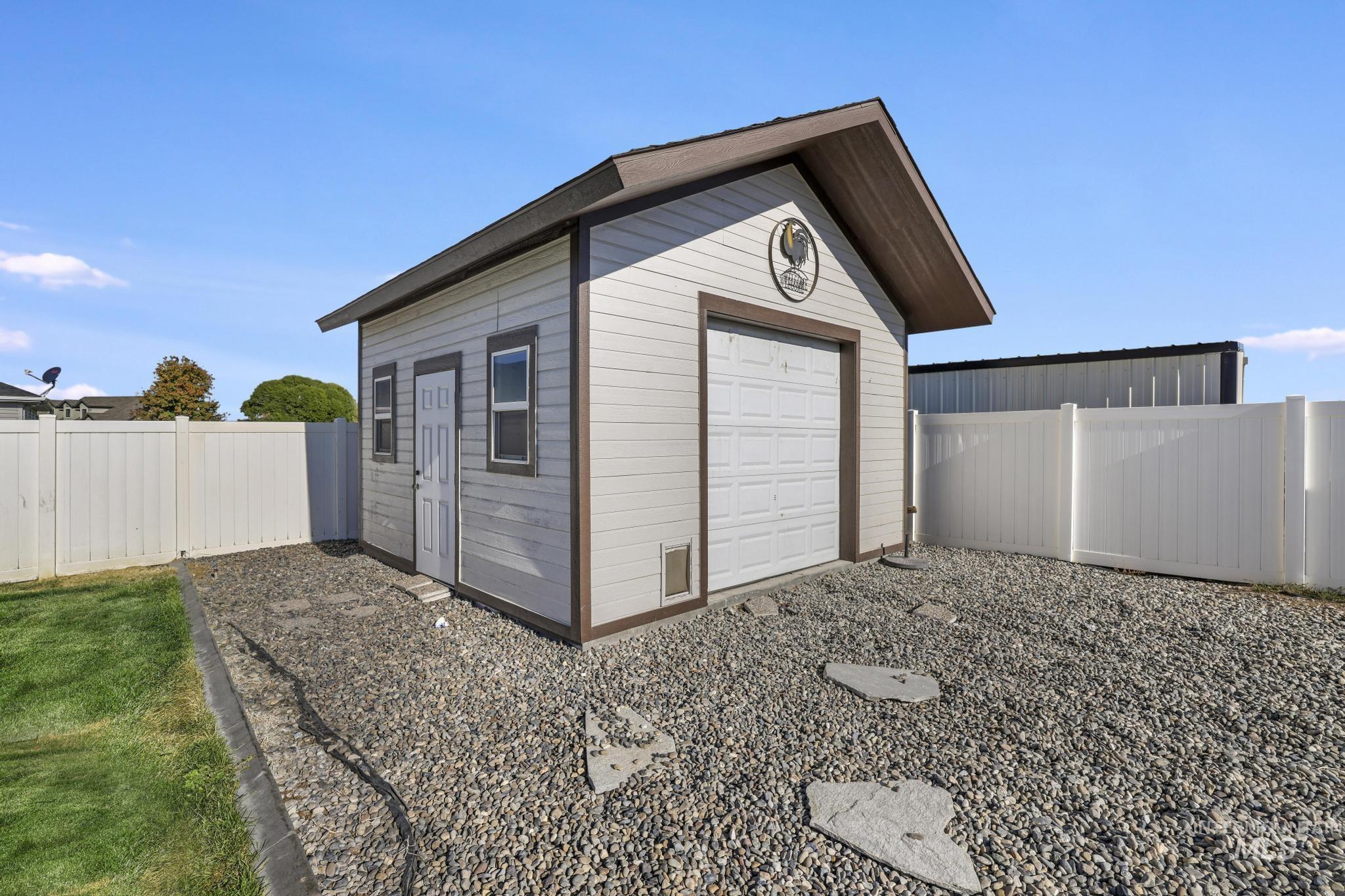 View of outbuilding featuring a fenced backyard and a garage