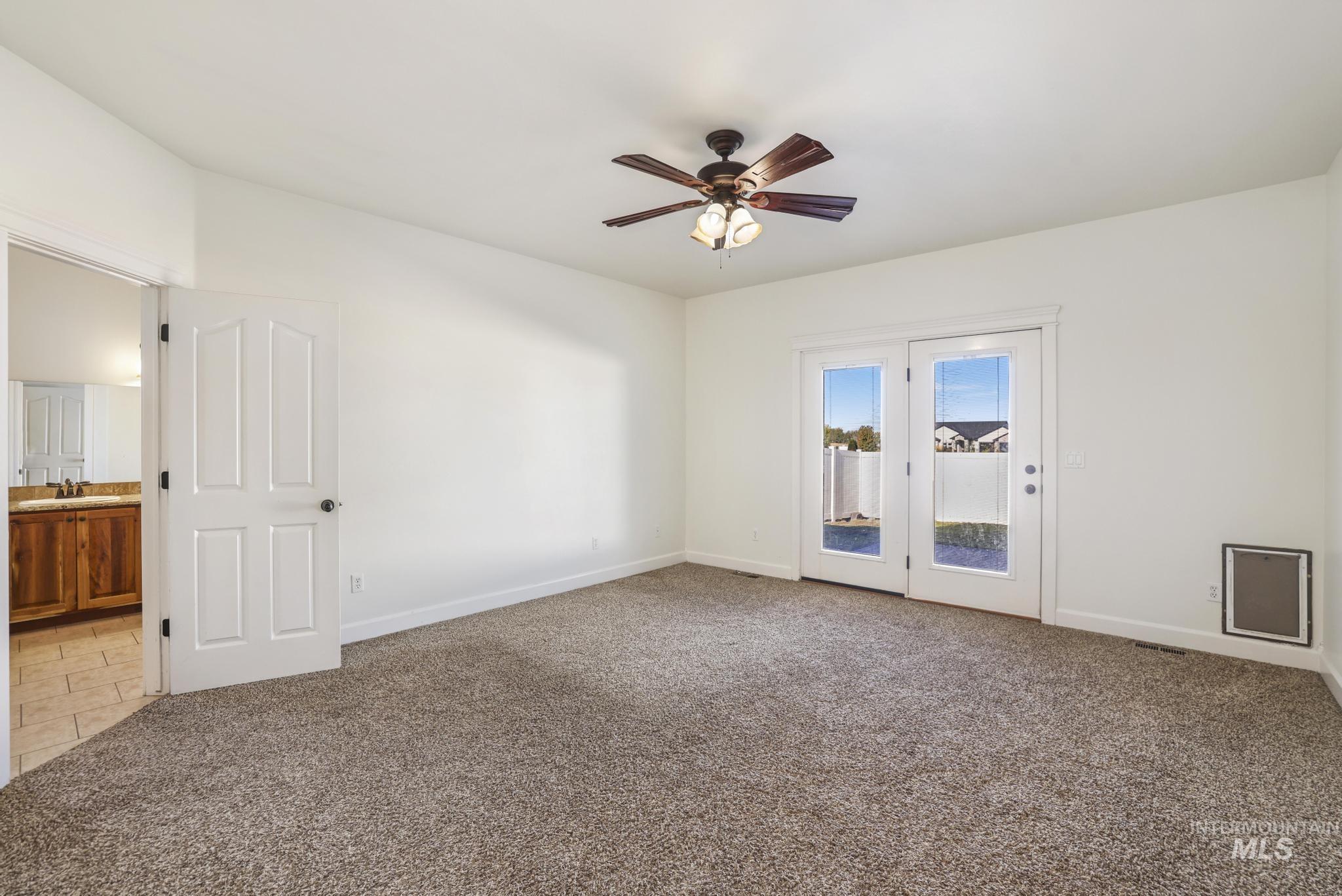 Spare room with light colored carpet and ceiling fan