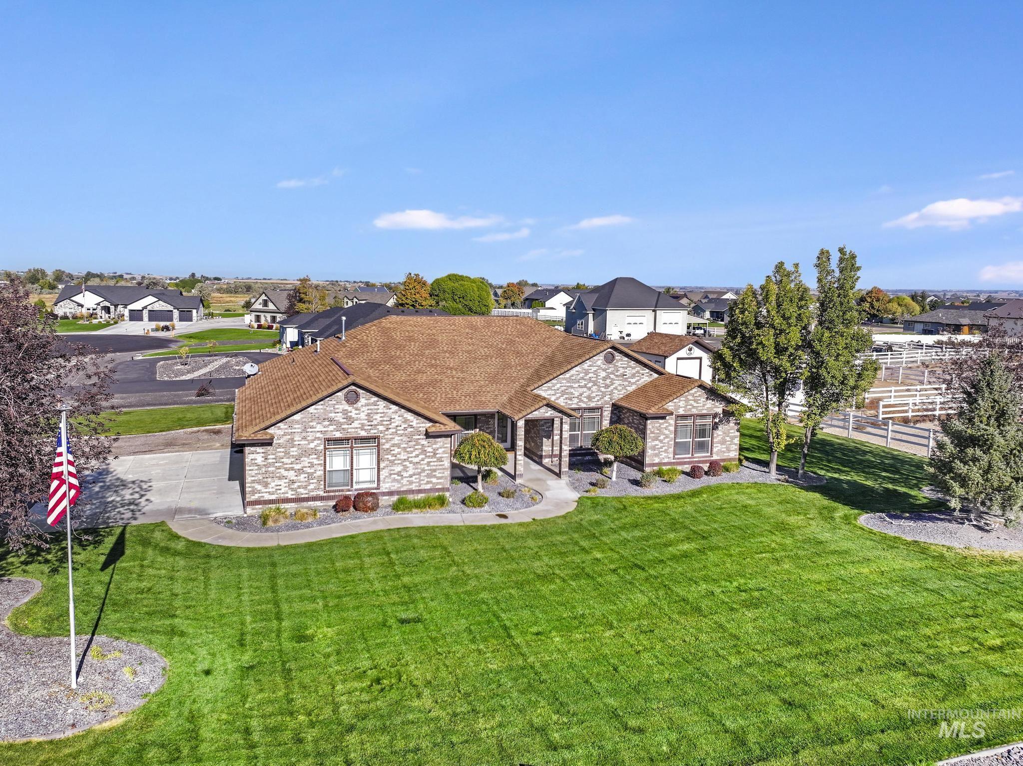 View of front of home featuring stone siding, a residential view, and brick siding