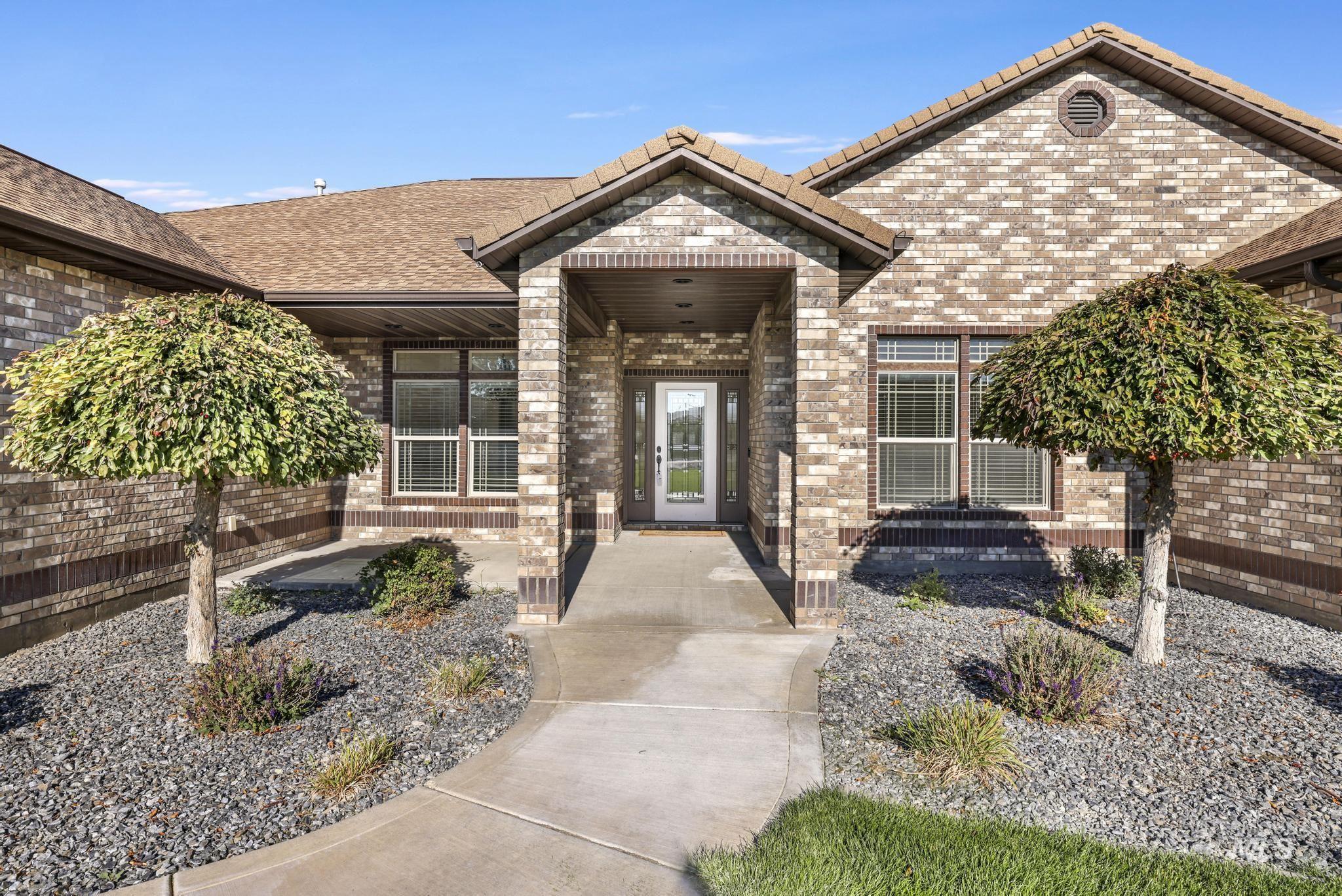 Entrance to property featuring brick siding