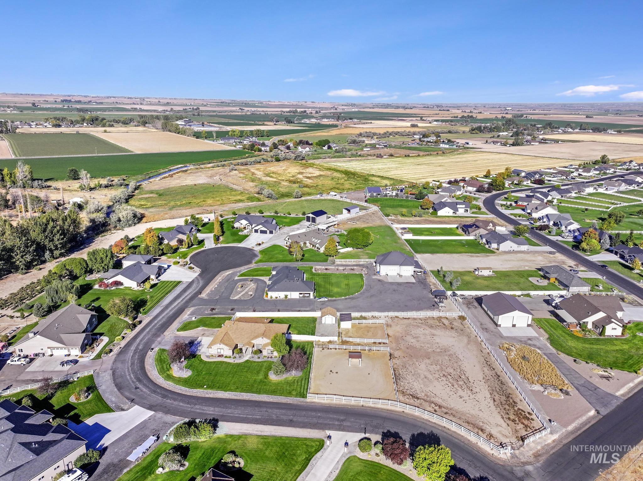 Aerial view of property and surrounding area with nearby suburban area