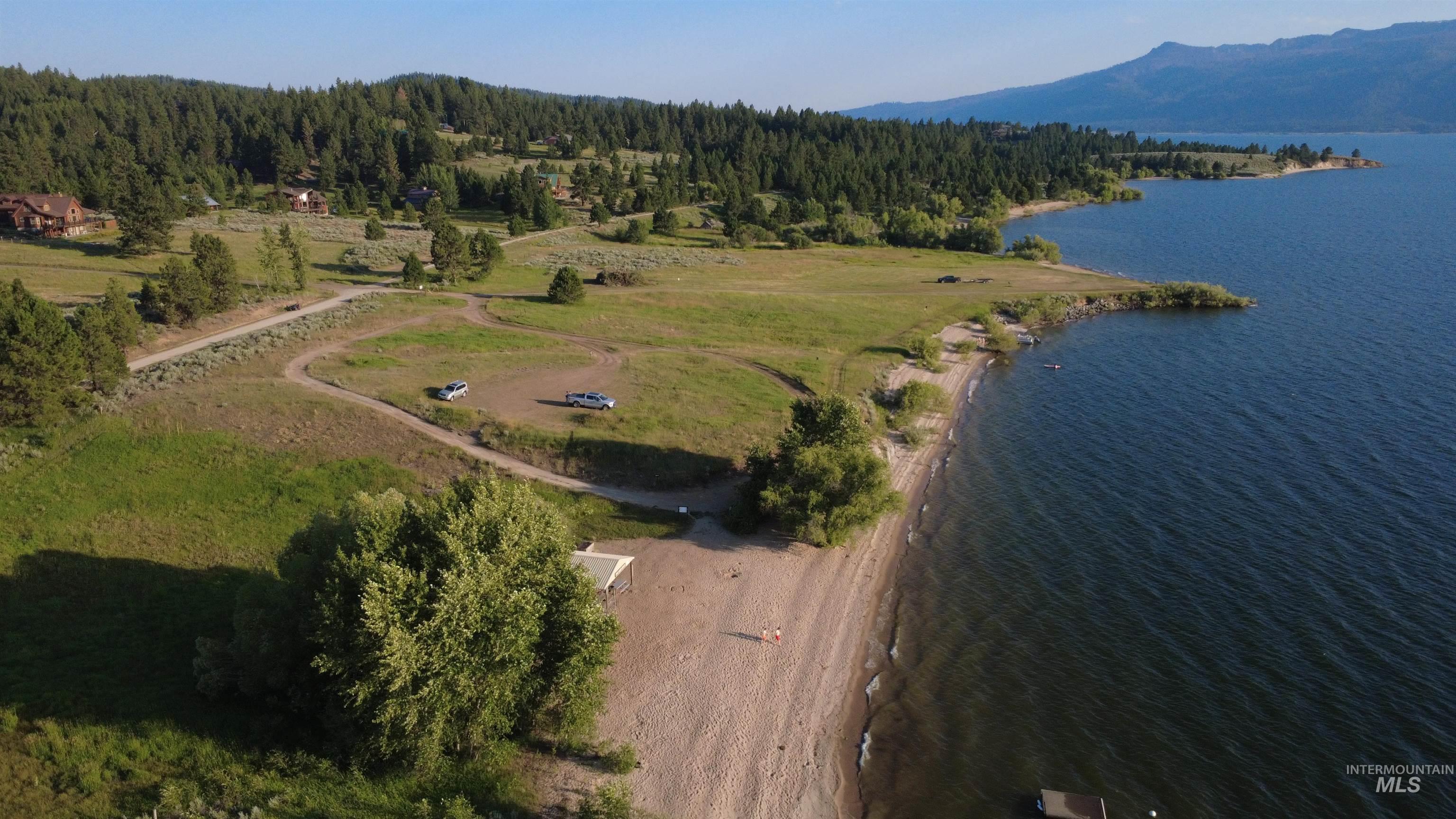 View of property location with a water and mountain view and a heavily wooded area
