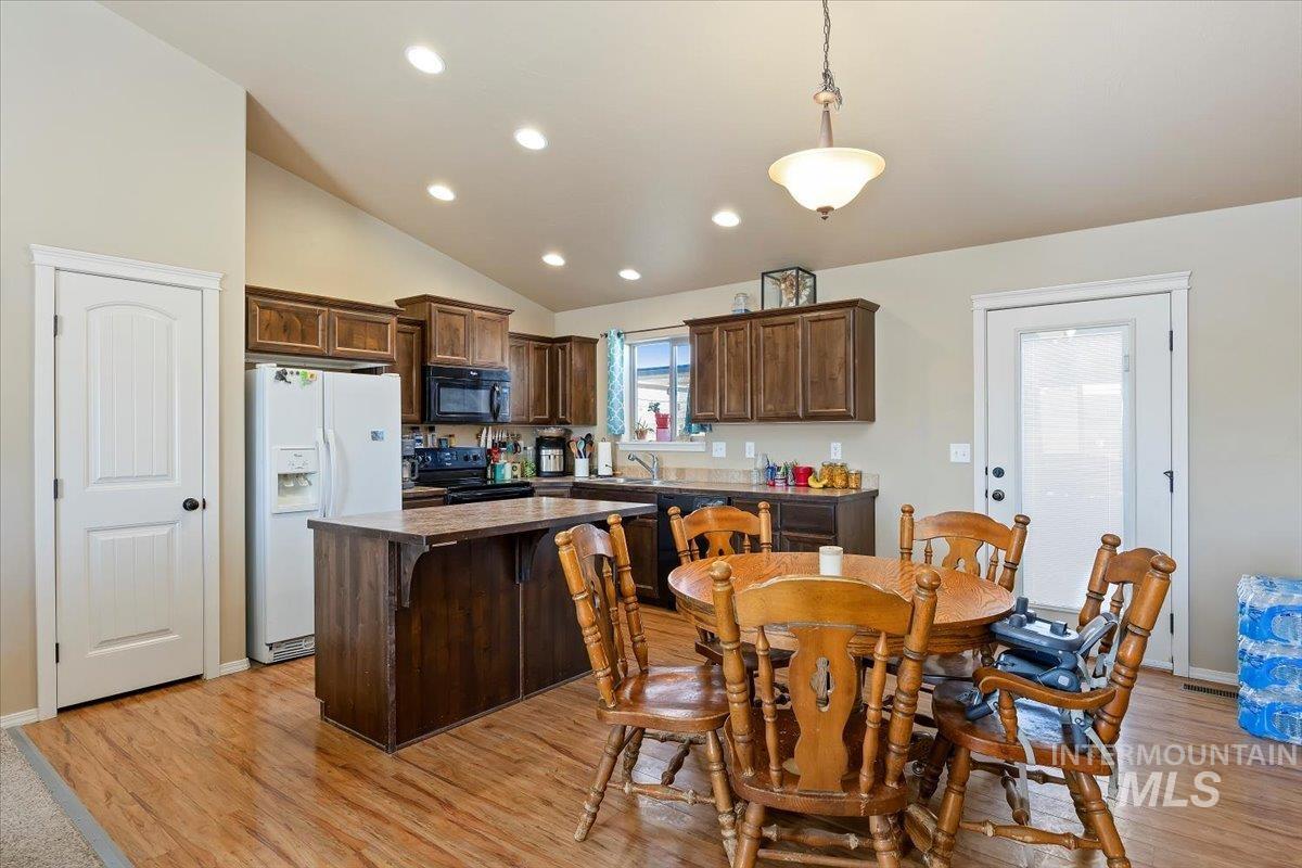 Dining area with vaulted ceiling.