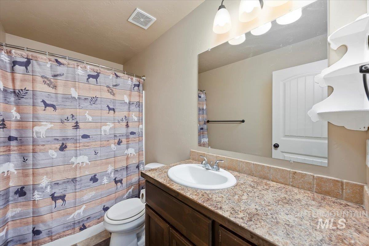 Full bathroom with vanity and toilet