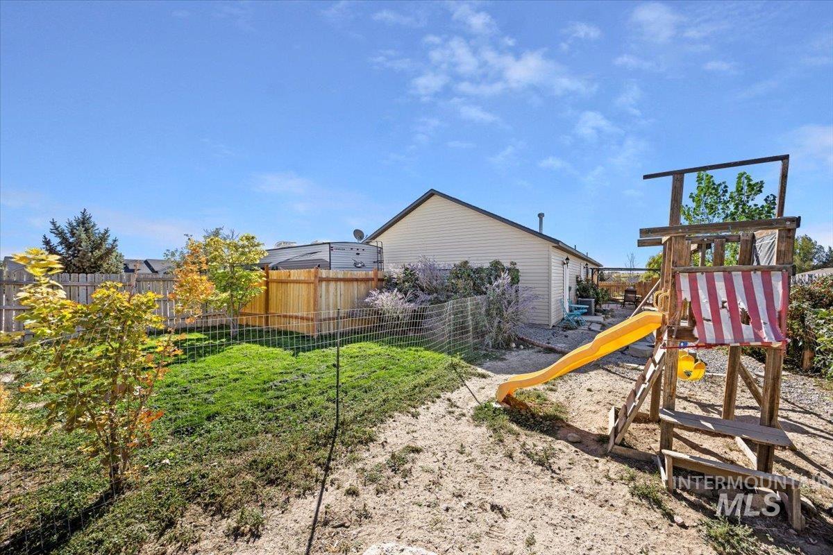 View of play area featuring a fenced backyard