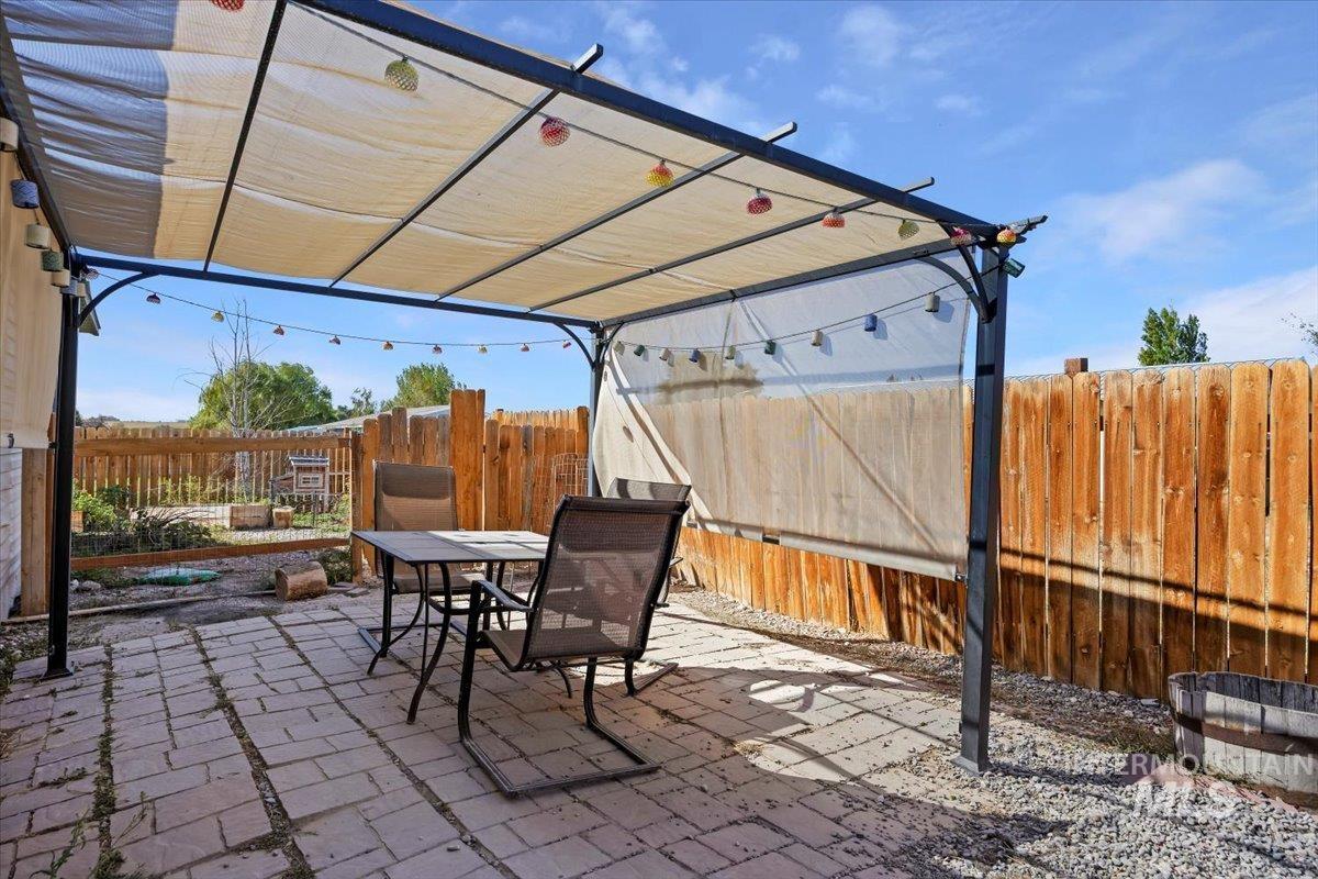 Fenced backyard with outdoor dining area and a patio area