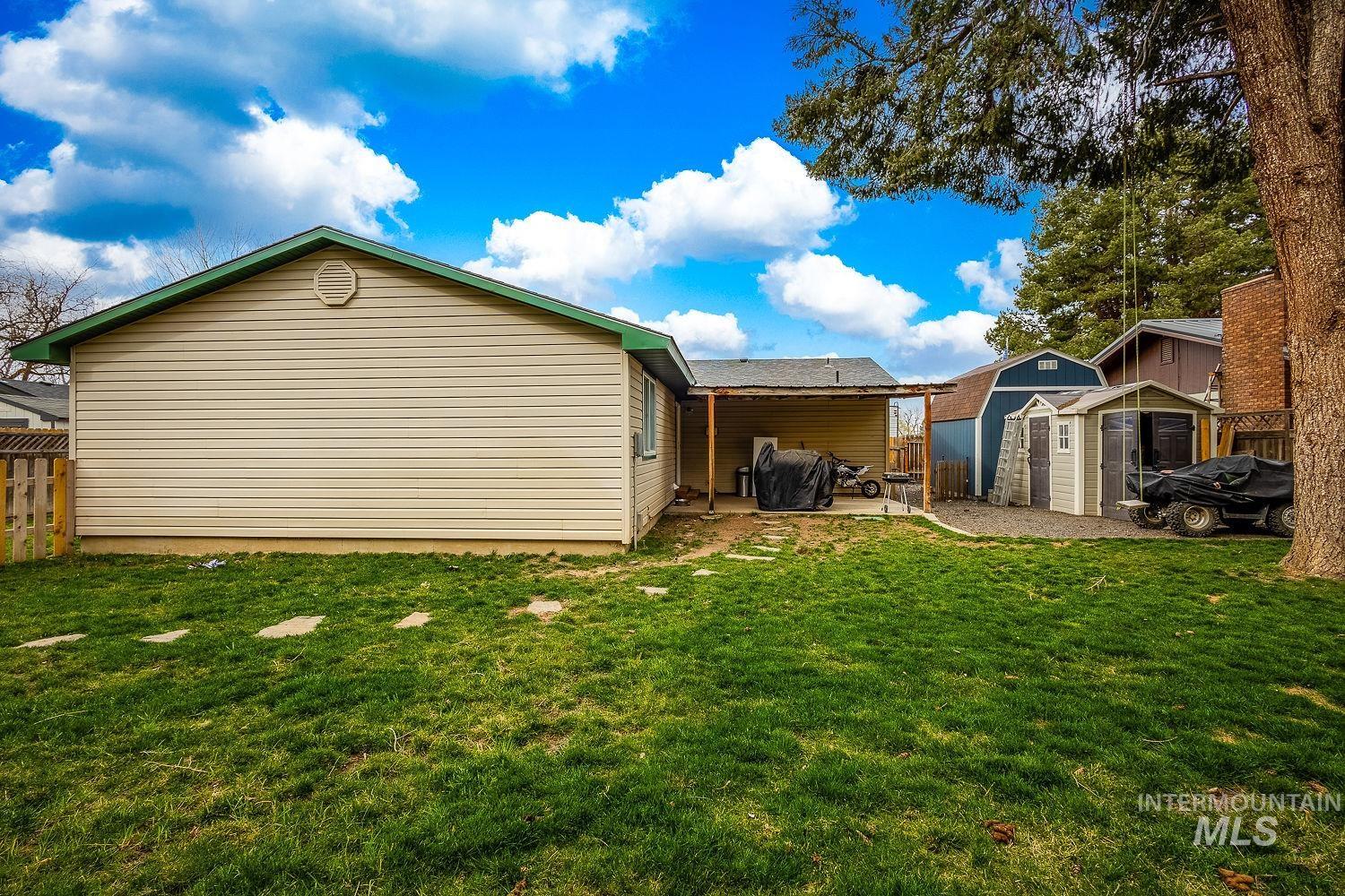 Back of house featuring a storage shed, a fenced backyard, and a patio