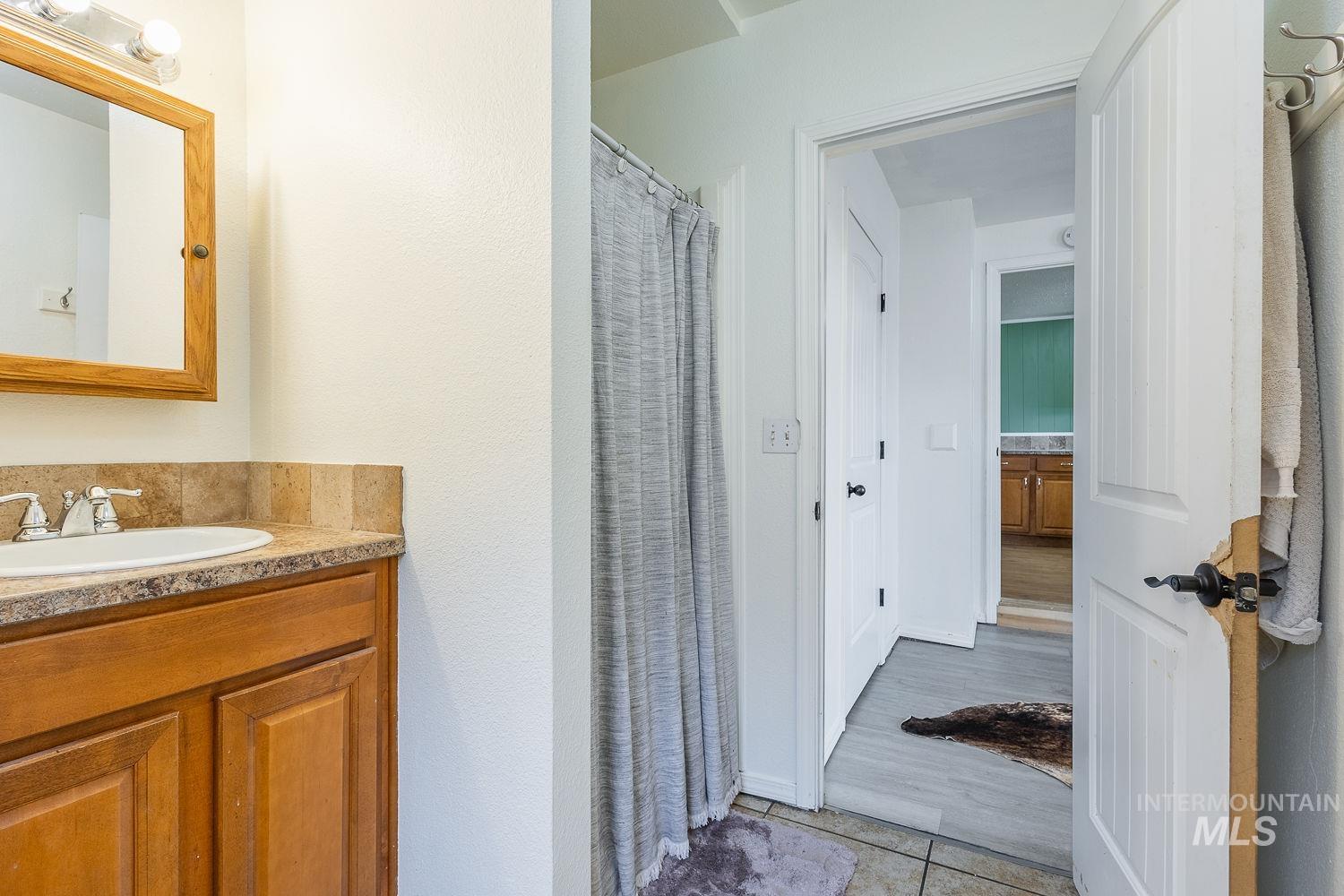 Bathroom with vanity and curtained shower