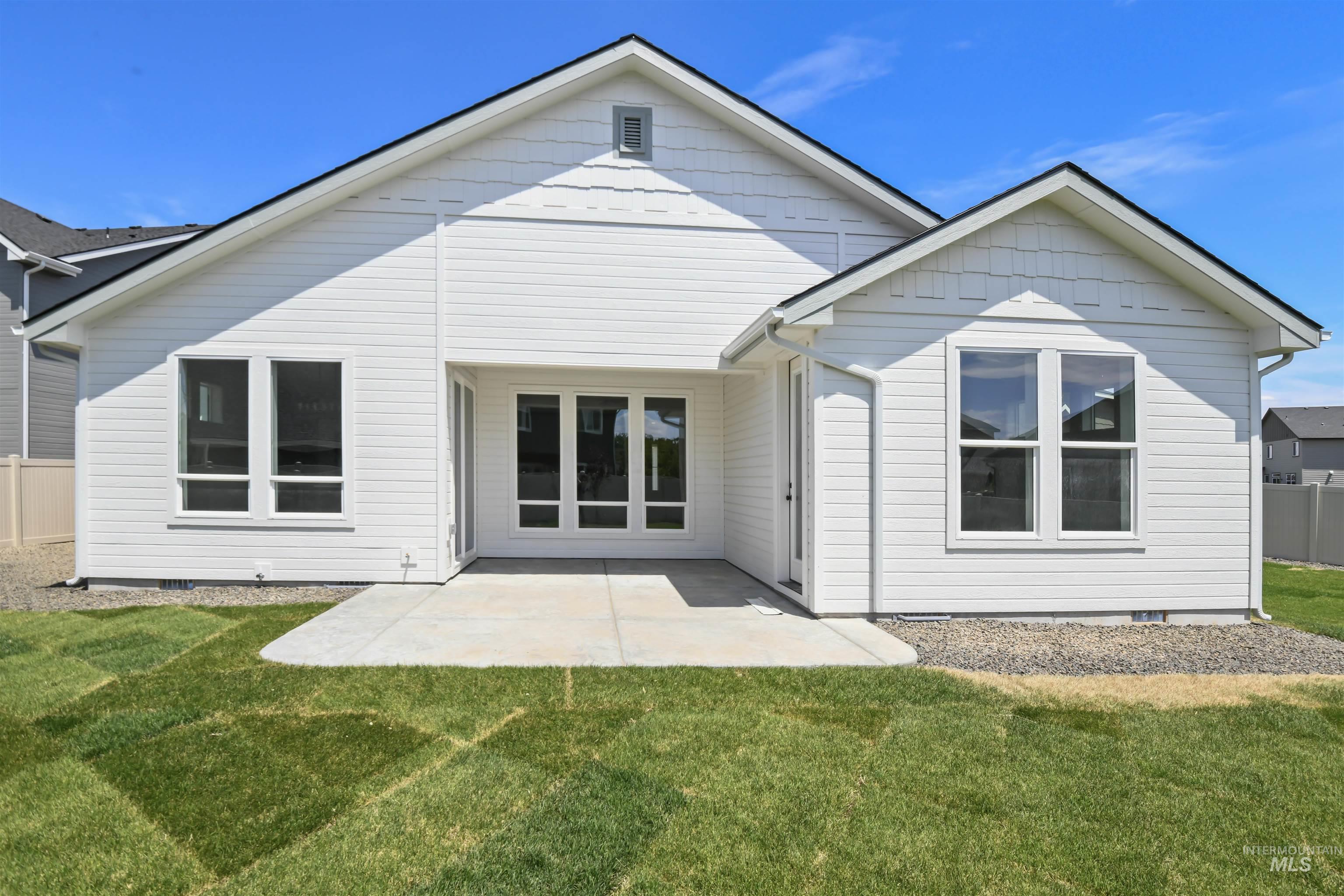 Rear view of house with a lawn, a patio, and crawl space