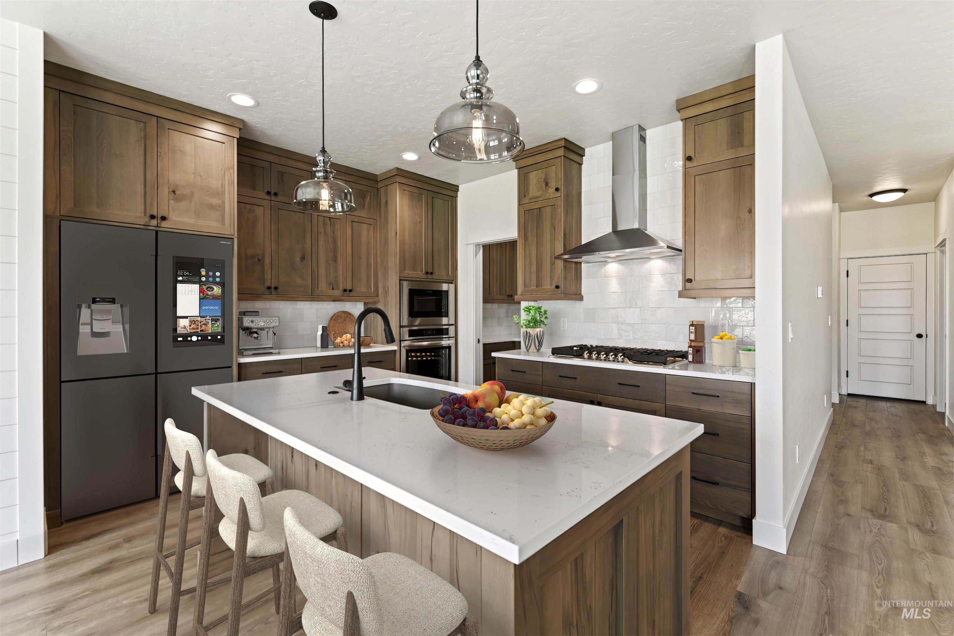 Kitchen featuring wall chimney range hood, stainless steel appliances, light wood finished floors, tasteful backsplash, and recessed lighting