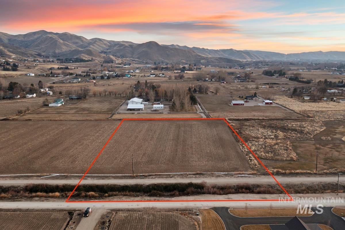 Overview of rural landscape featuring property parcel outlined and a mountain backdrop