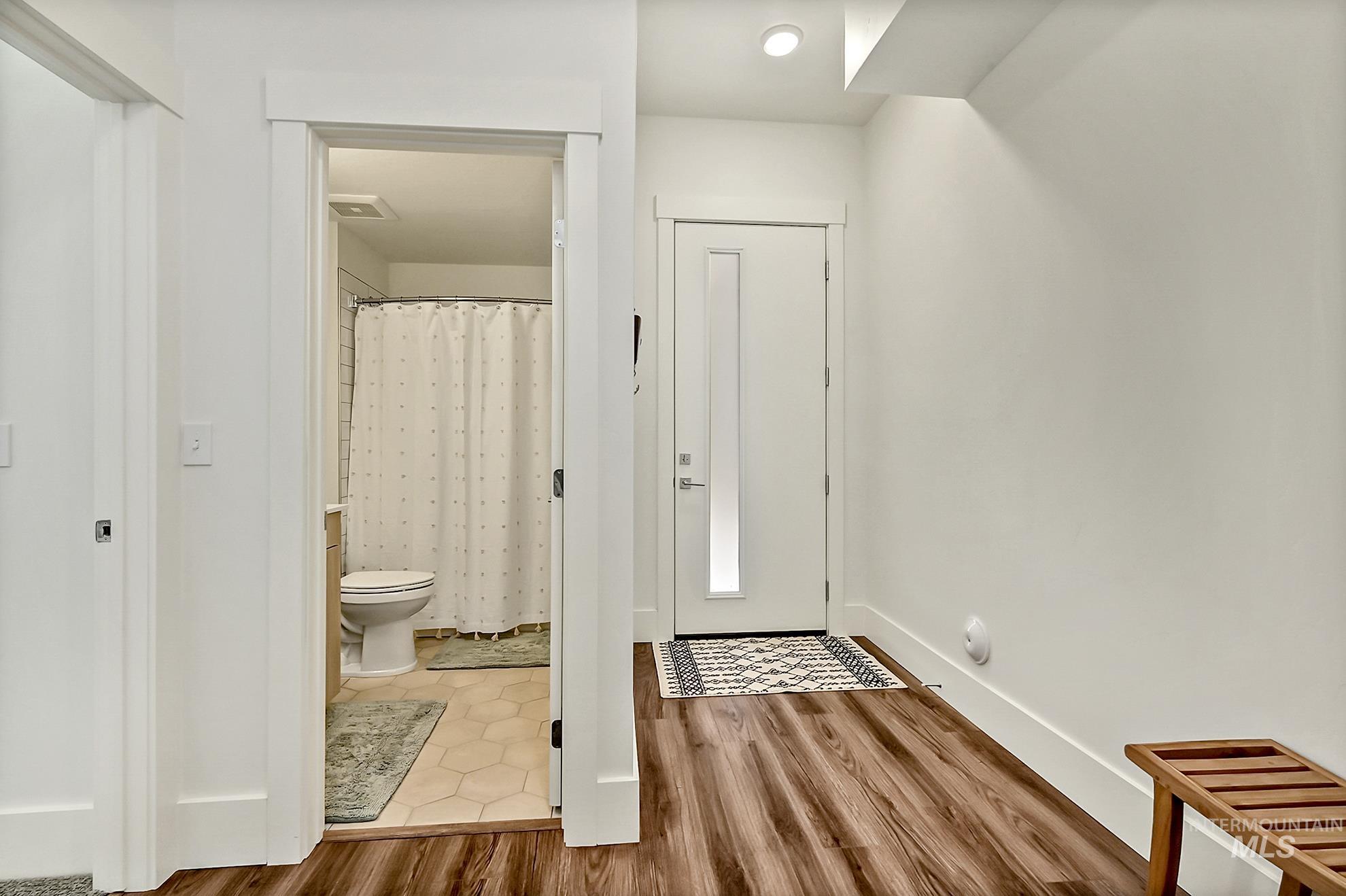 Entrance foyer with wood finished floors and baseboards