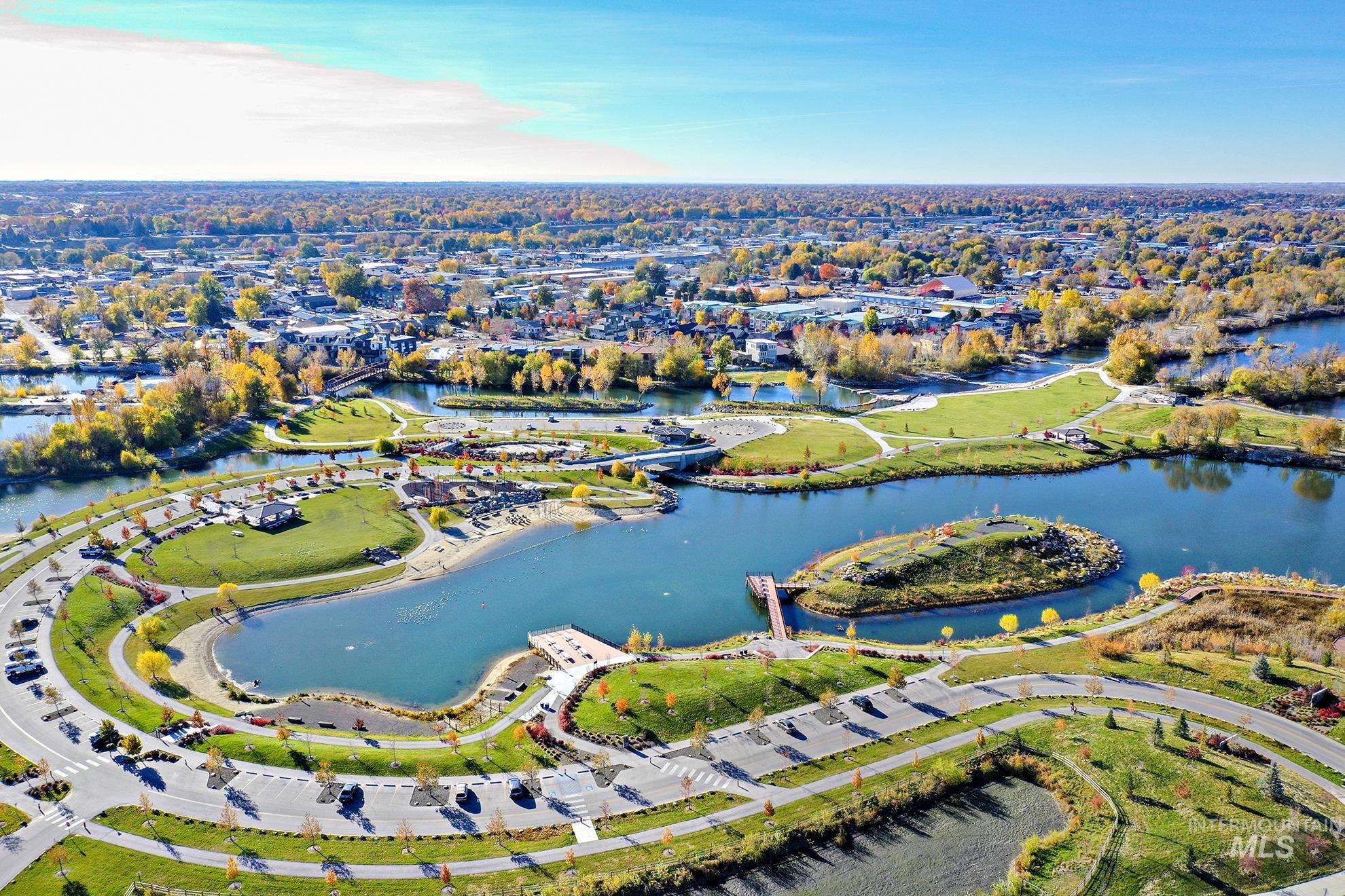 Aerial view of property and surrounding area with a nearby body of water