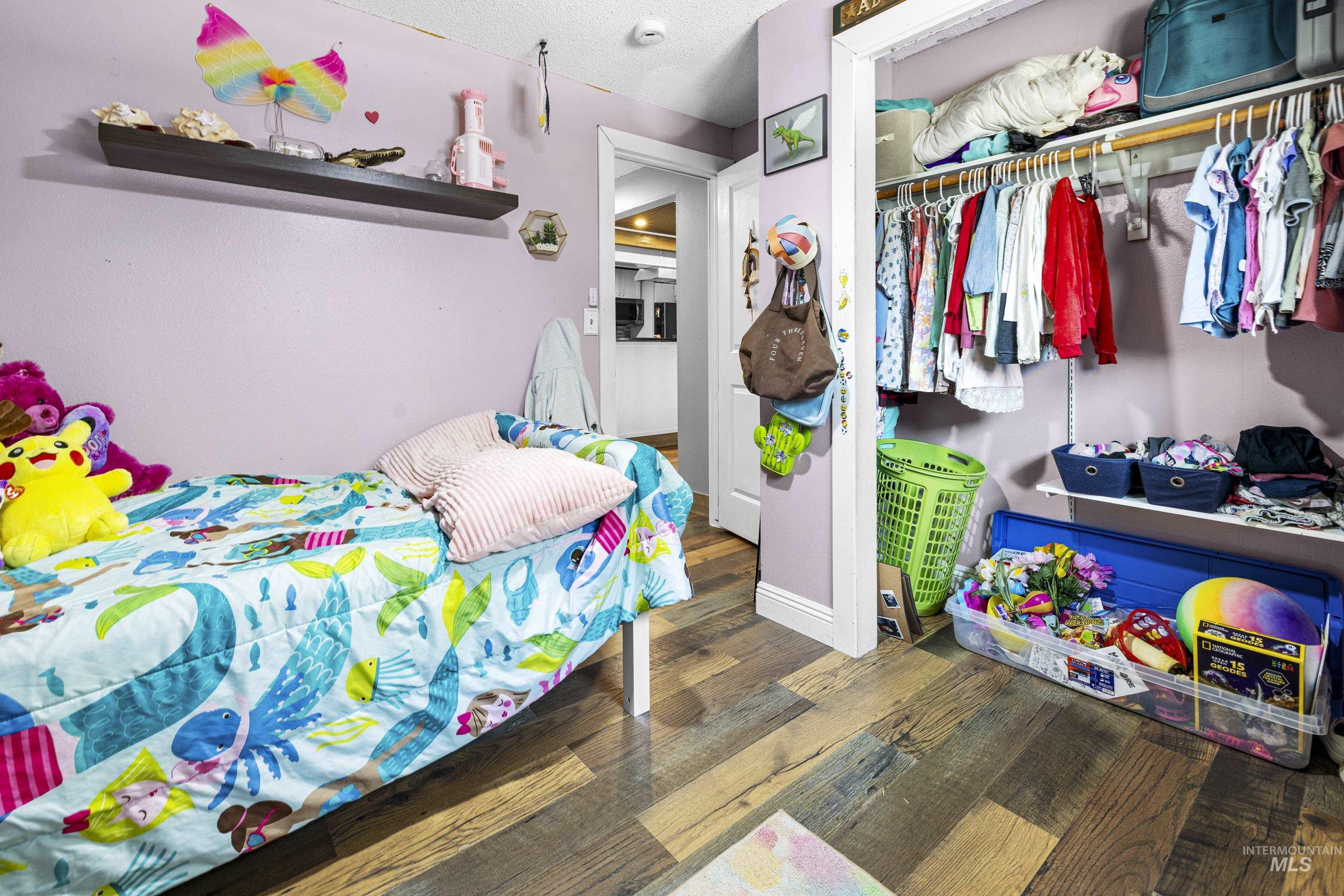 Bedroom featuring a closet and wood finished floors
