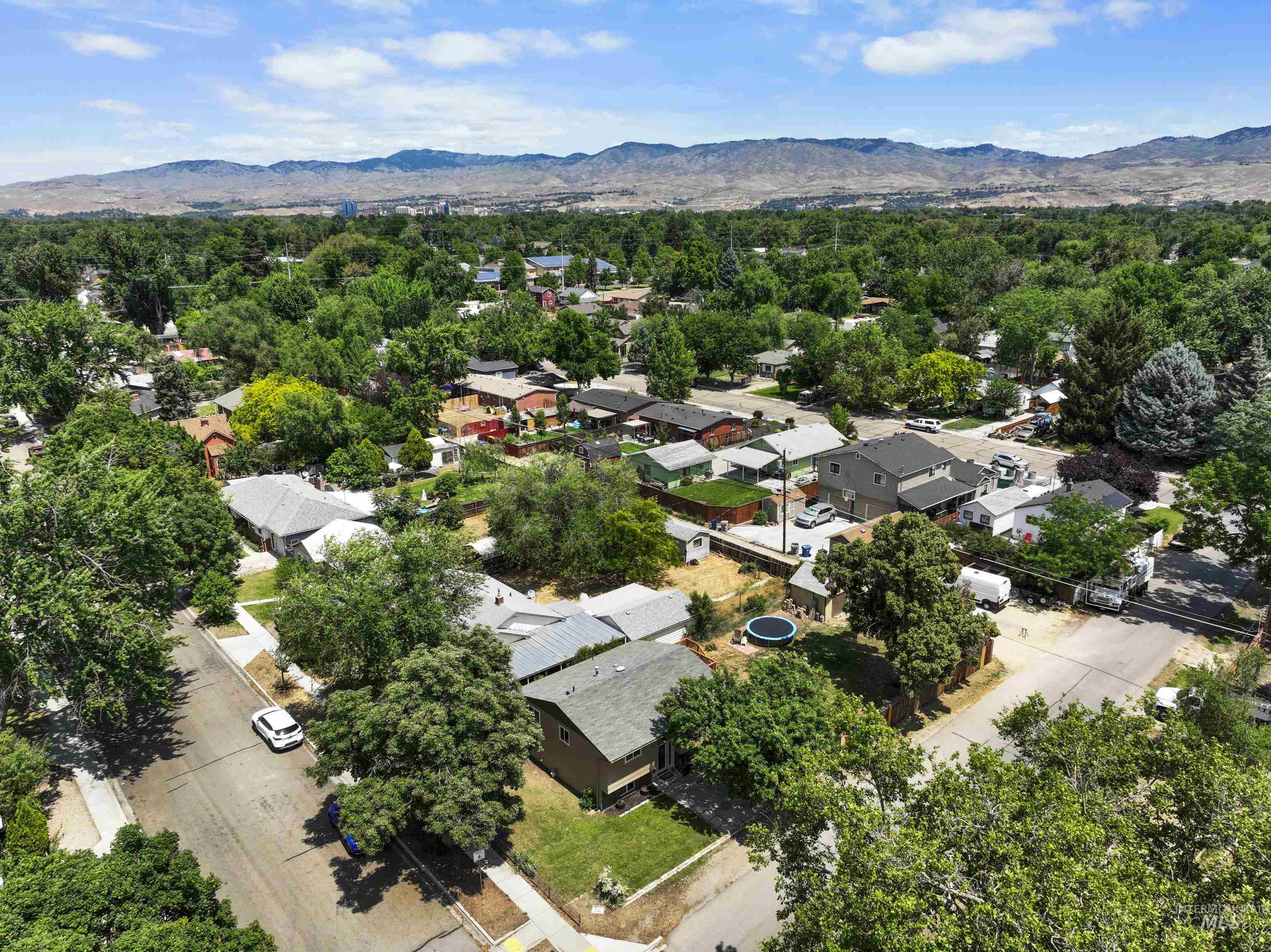 Aerial perspective of suburban area with a mountain backdrop