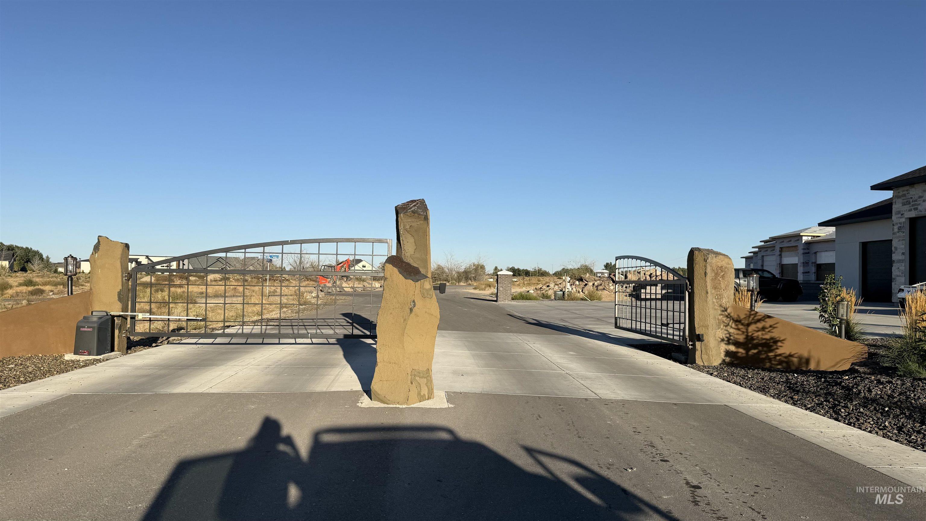 View of concrete road featuring a gate