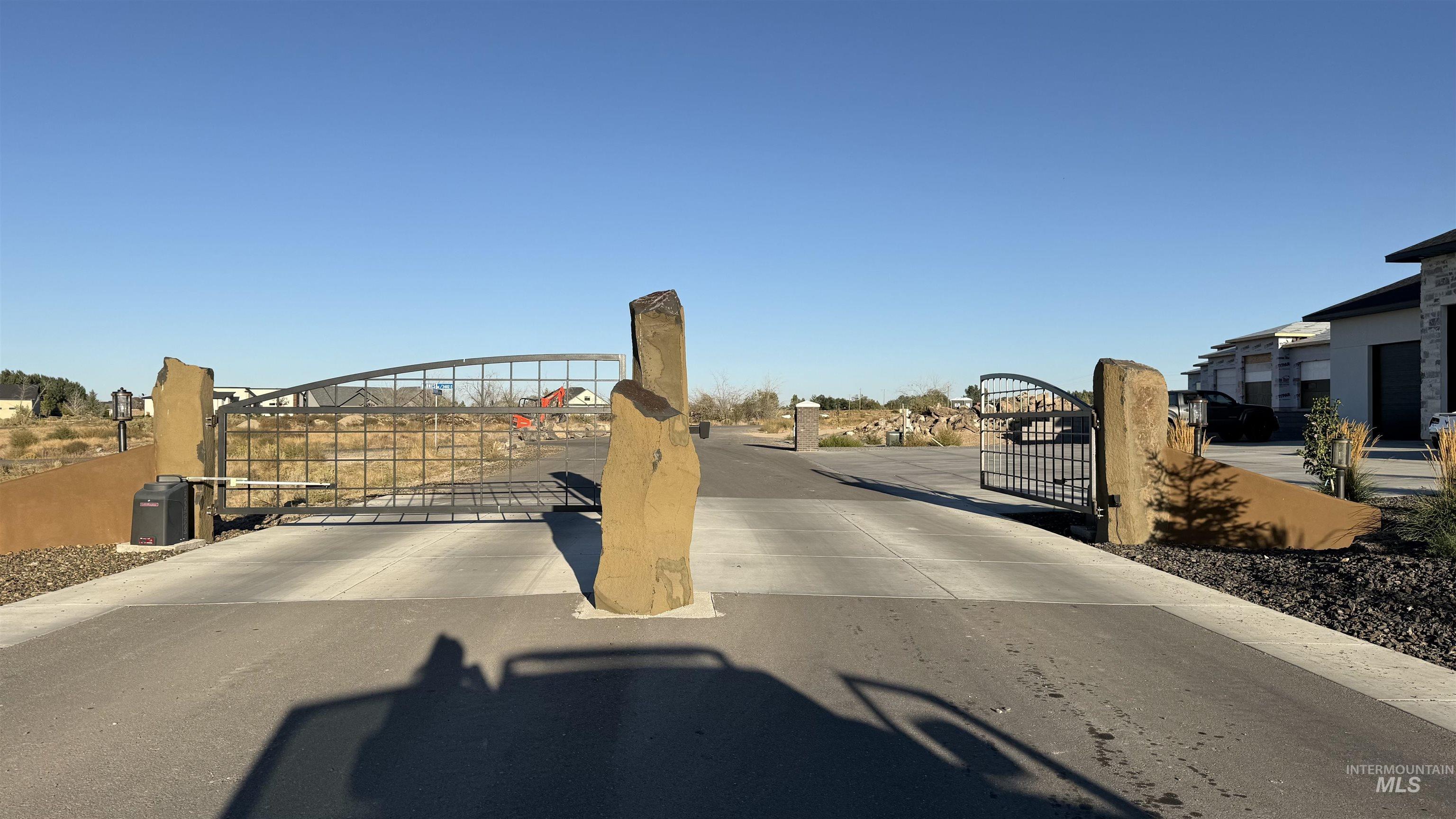 View of concrete road featuring a gate
