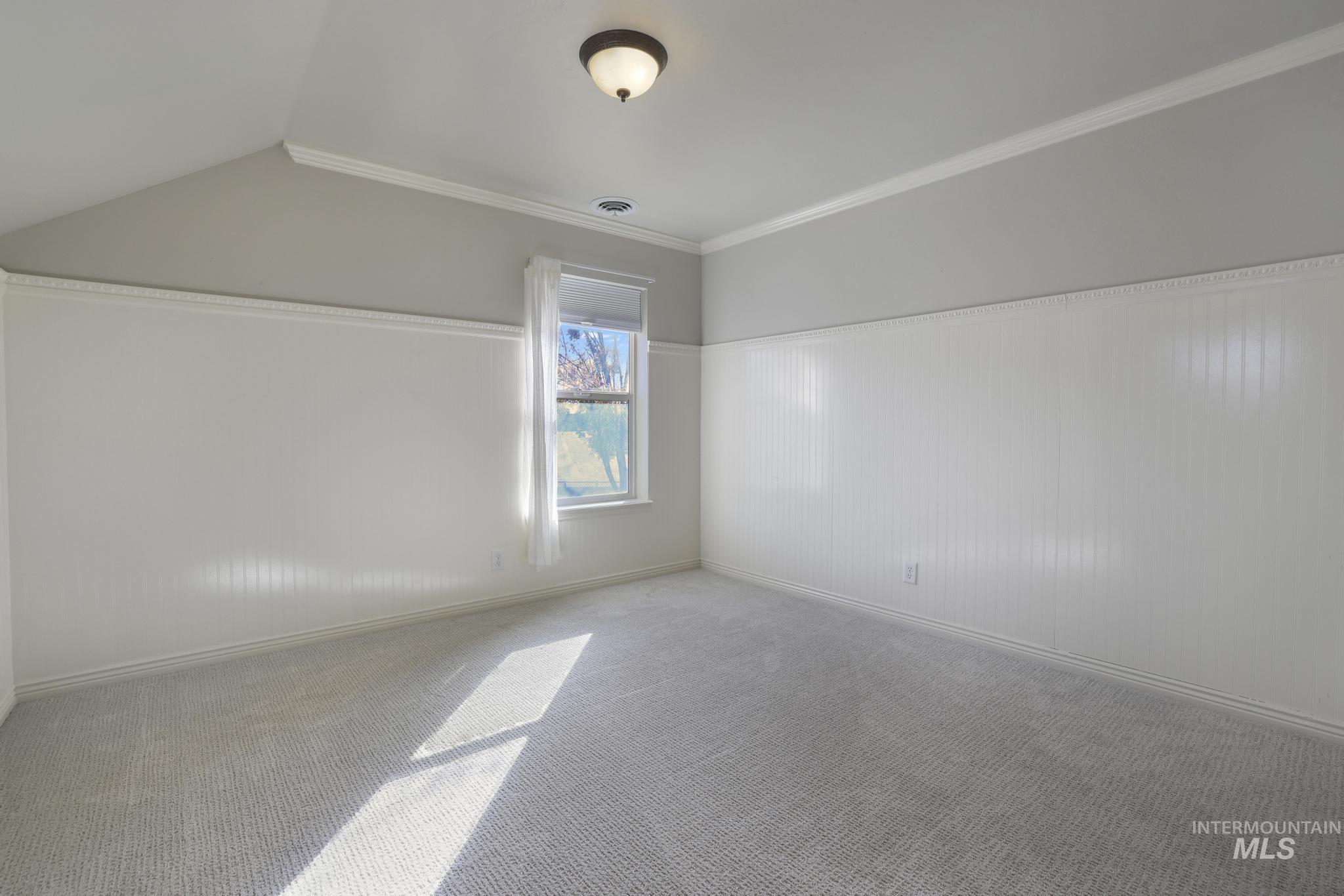 Additional living space with wainscoting and carpet